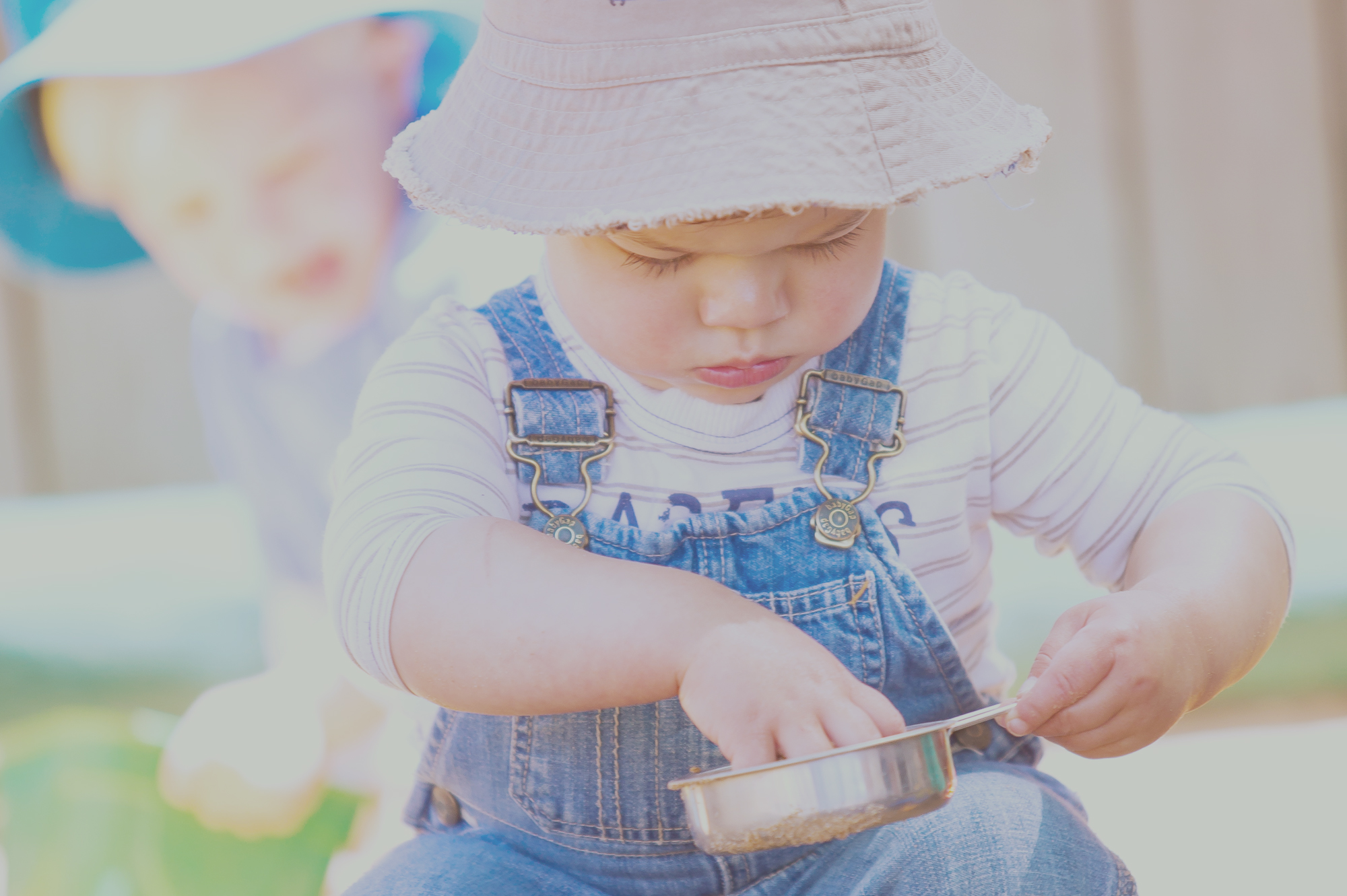 Baby Playing With Skillet In Montessori Child Care