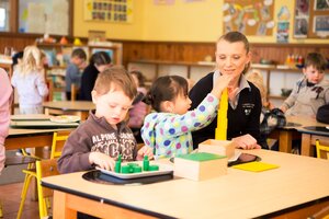 Teacher providing montessori education to children at A Country Garden