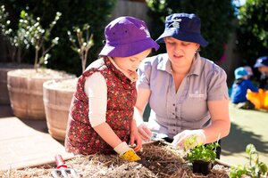 A Country Garden Teacher Assisting Preschooler