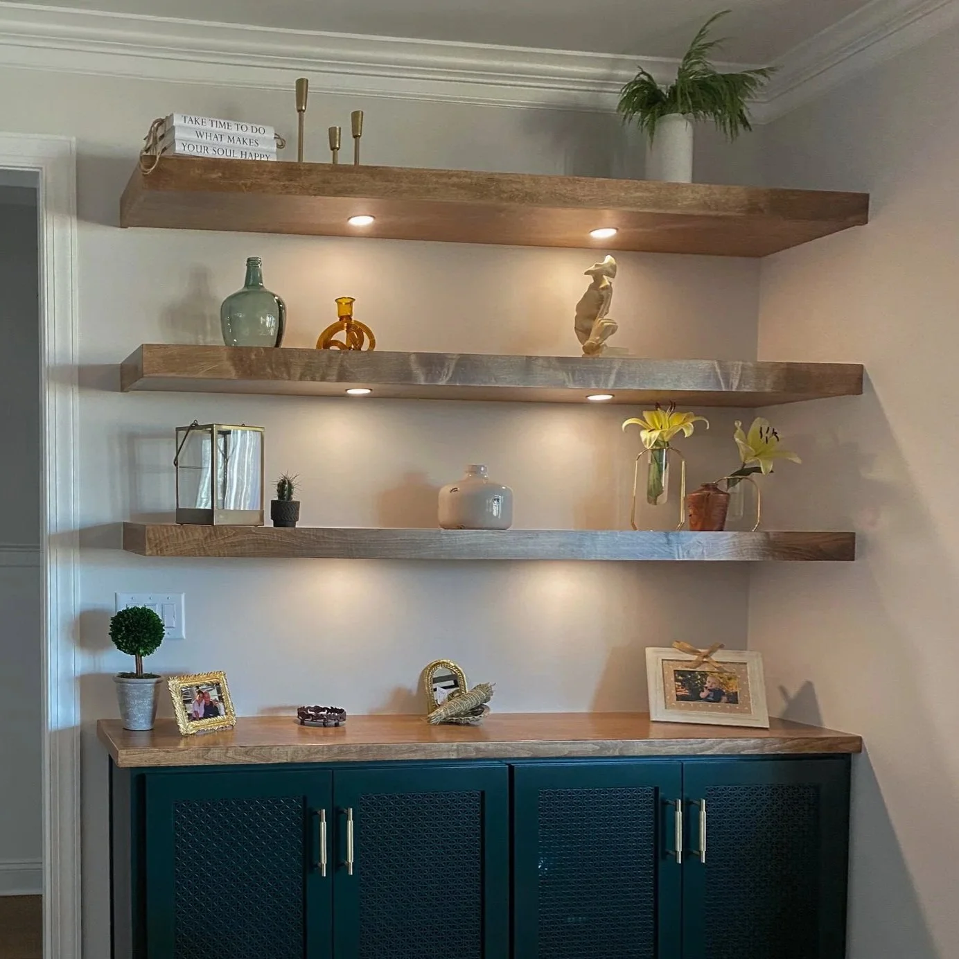 Living Room Built-Ins with Floating Shelves and Puck Lighting