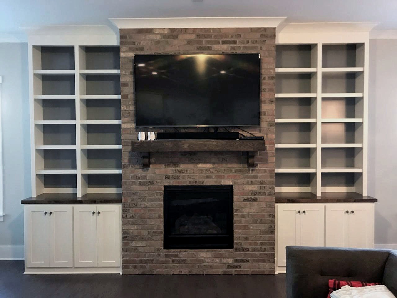 Fireplace Built-Ins with Adjustable Shelves, Accent Backer Color, Shaker Doors, and Crown
