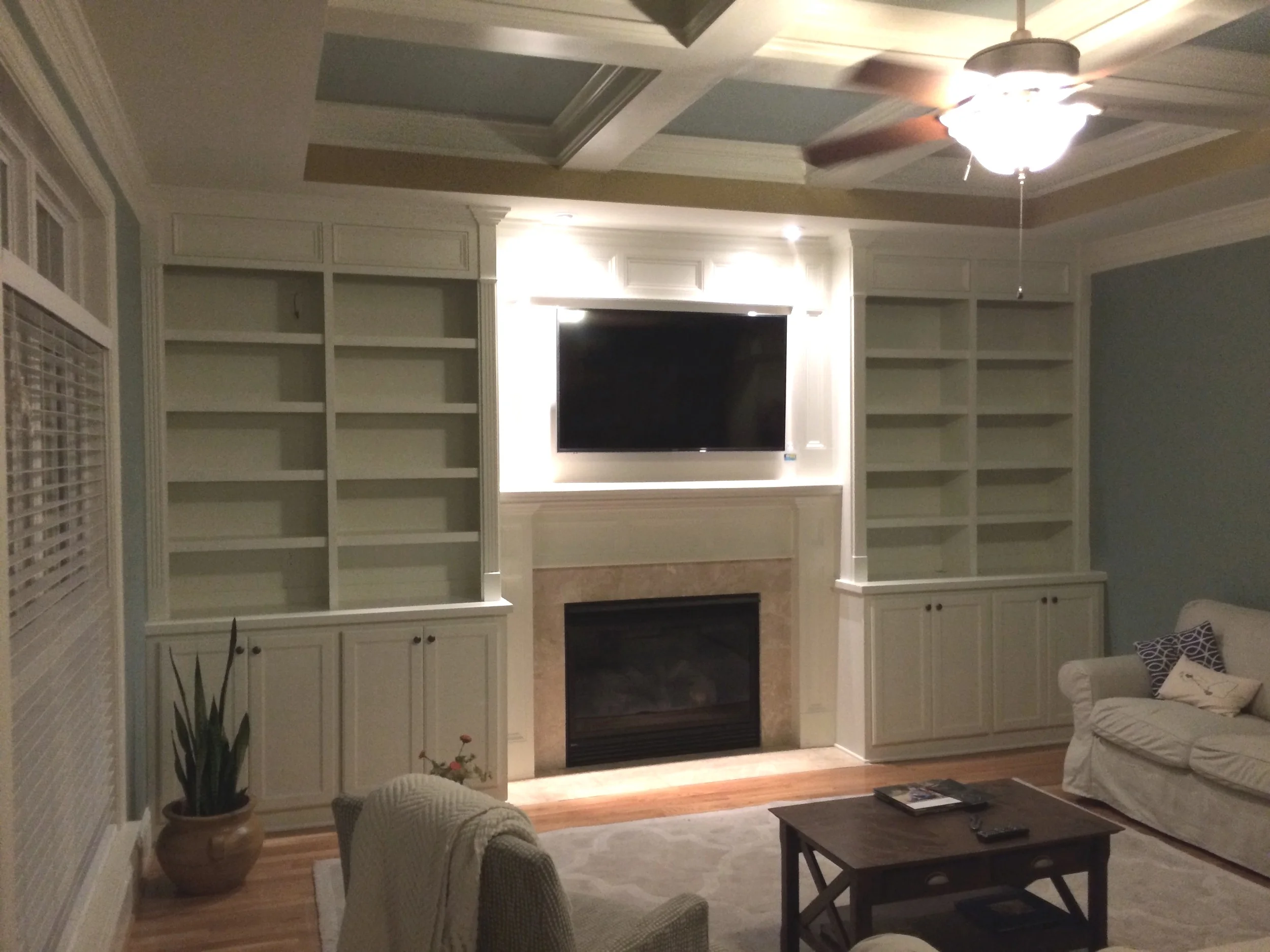 Fireplace Built-Ins with Adjustable Shelves, Shaker Doors, Applied Panel Header Detail, and Crown