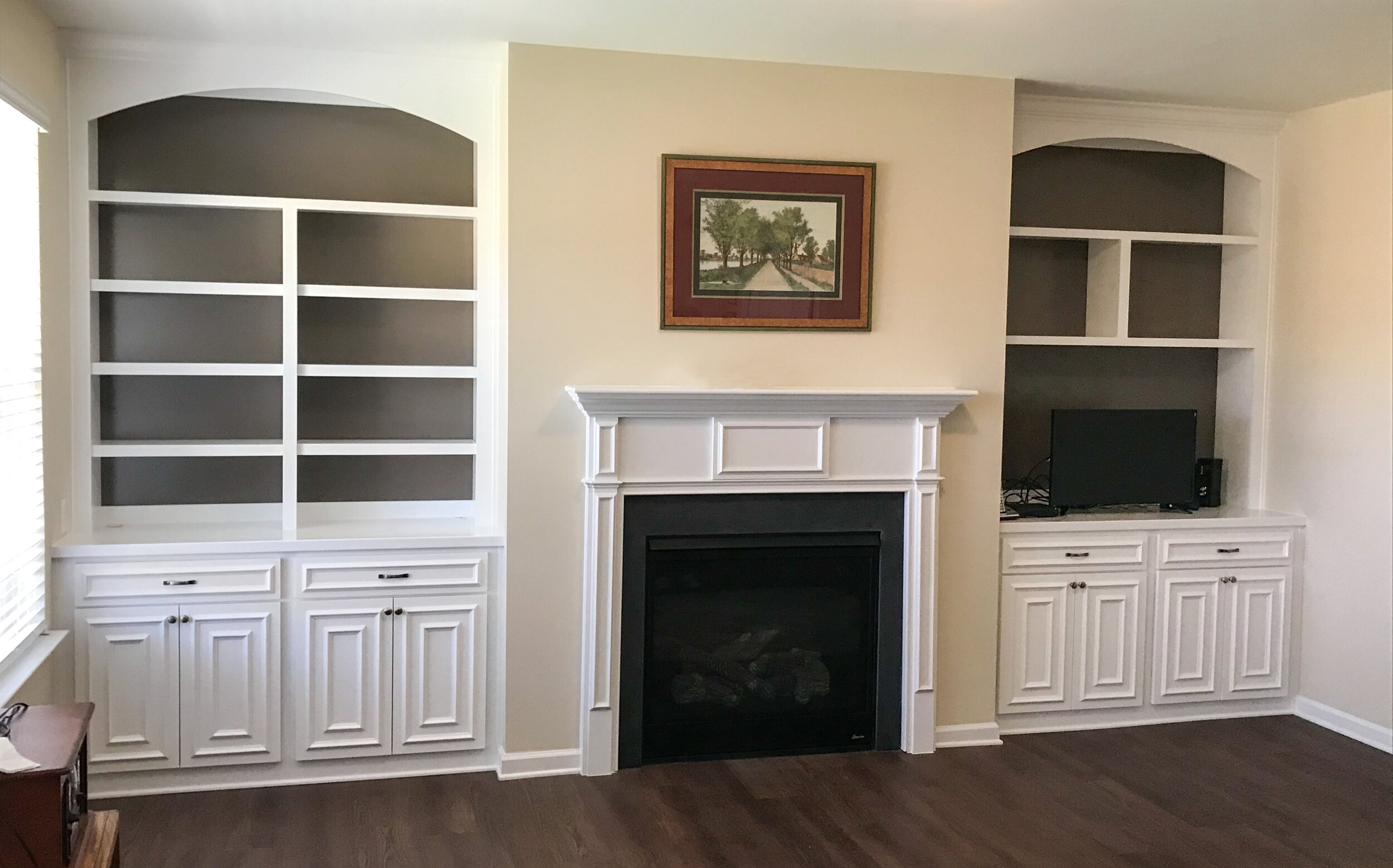 Built in 2024 bookshelves beside fireplace