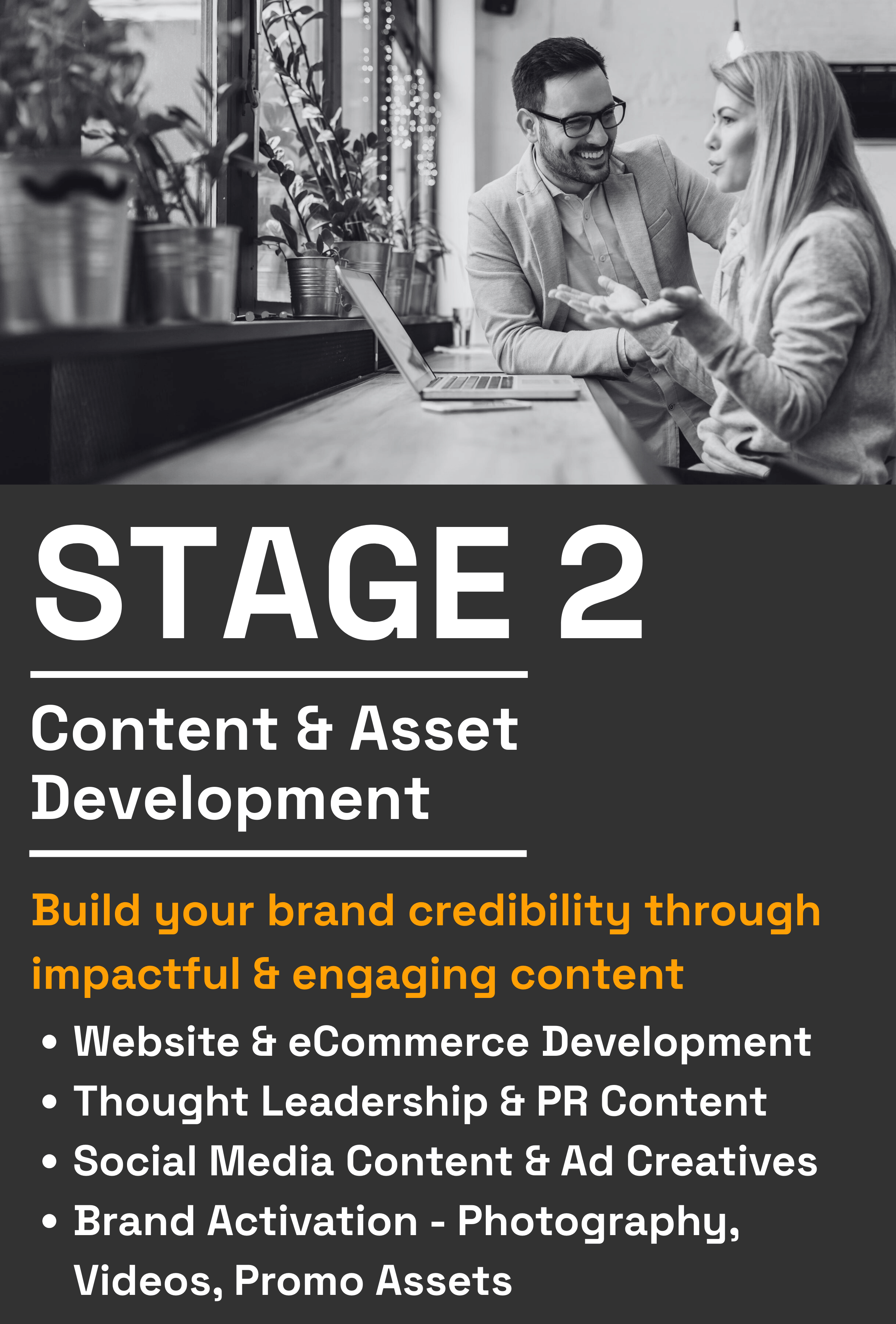 A black and white photo of two people, a man and a woman, sitting at a table in a cafe, engaged in conversation. There are potted plants on the windowsill and a laptop open on the table.