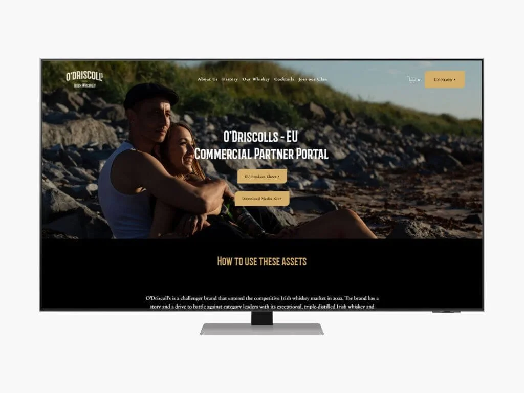 Screenshot of O'Driscoll's commercial partner portal website, showing two people sitting on a rocky beach during sunset, with navigation menu and buttons for product sheet and media kit.