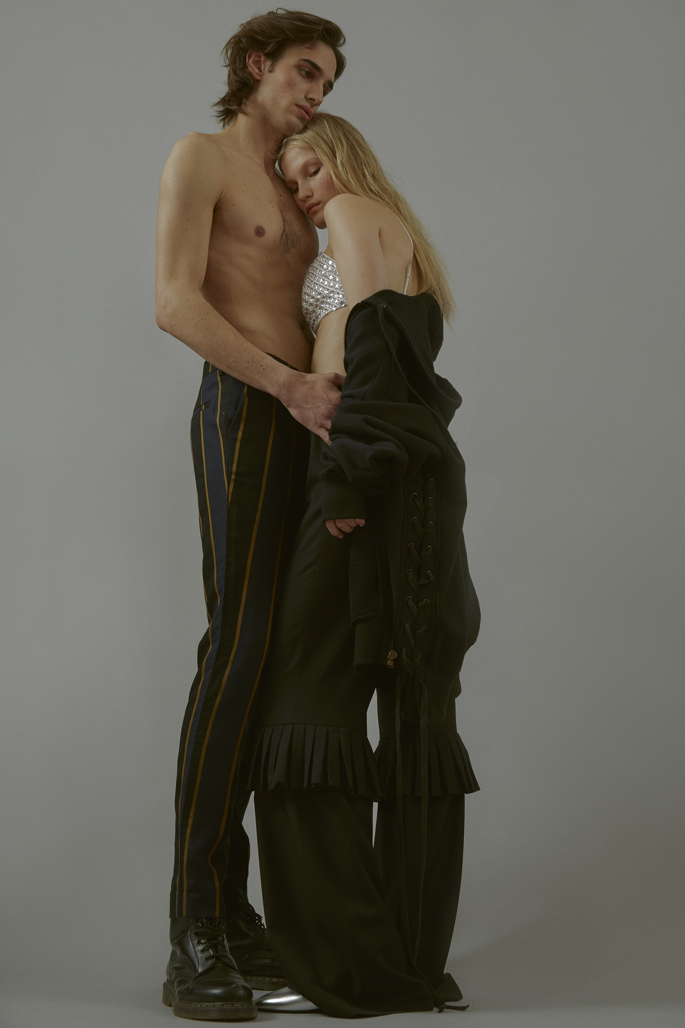 Philip wears Trousers Sean Suen Shoes Dr Martens Ali wears Bra BACK Sweatshirt Faith Connexion Trousers Anne Sofie Madsen Shoes Pierre Hardy