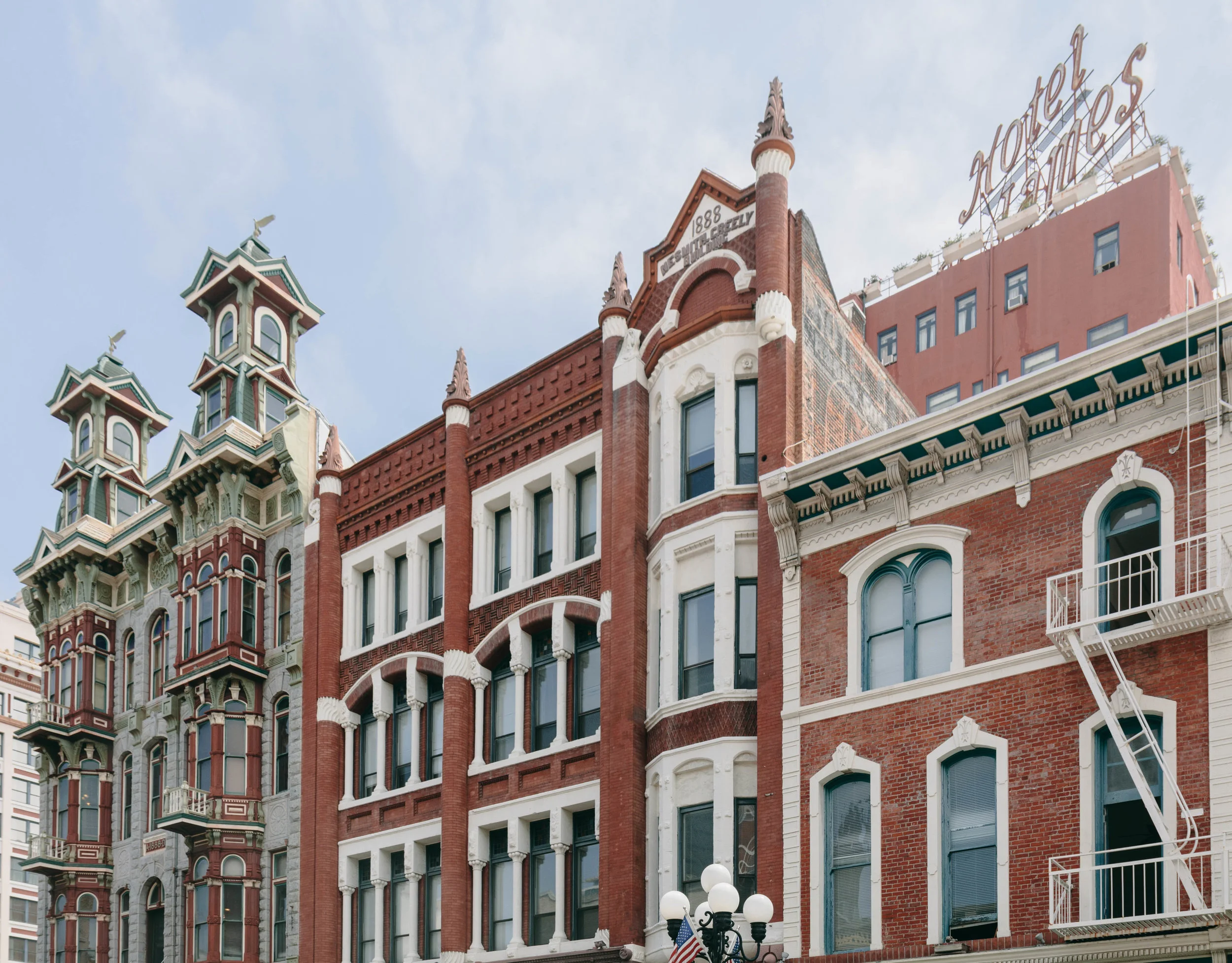 Left: Louis Bank of Commerce in the Baroque Revival Style (1888), which once housed an oyster bar frequented by Wyatt Earp. Right: NeSmith-Greeley Building in the Romanesque Revival Style (1888). The sign for the historic Hotel St. James (1913) can be seen in the background.
