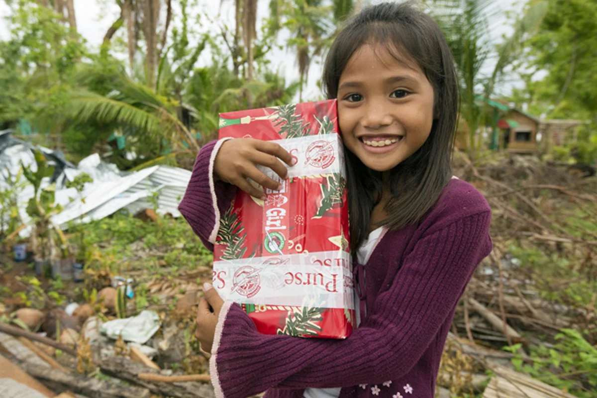 Child receiving an Operation Christmas Child gift