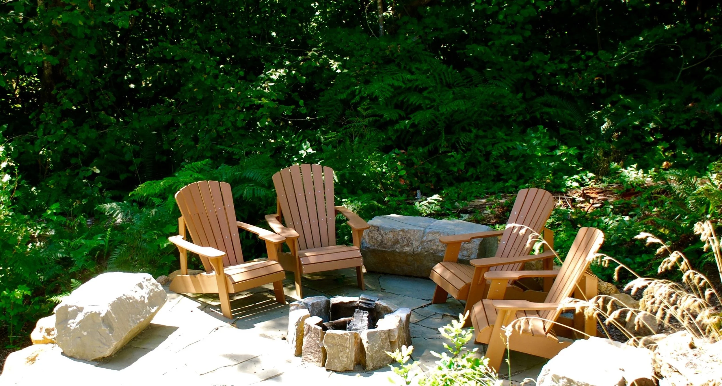 Country House IV. Fire pit tucked into the landscape. Boulders for sitting and flagstone patio.