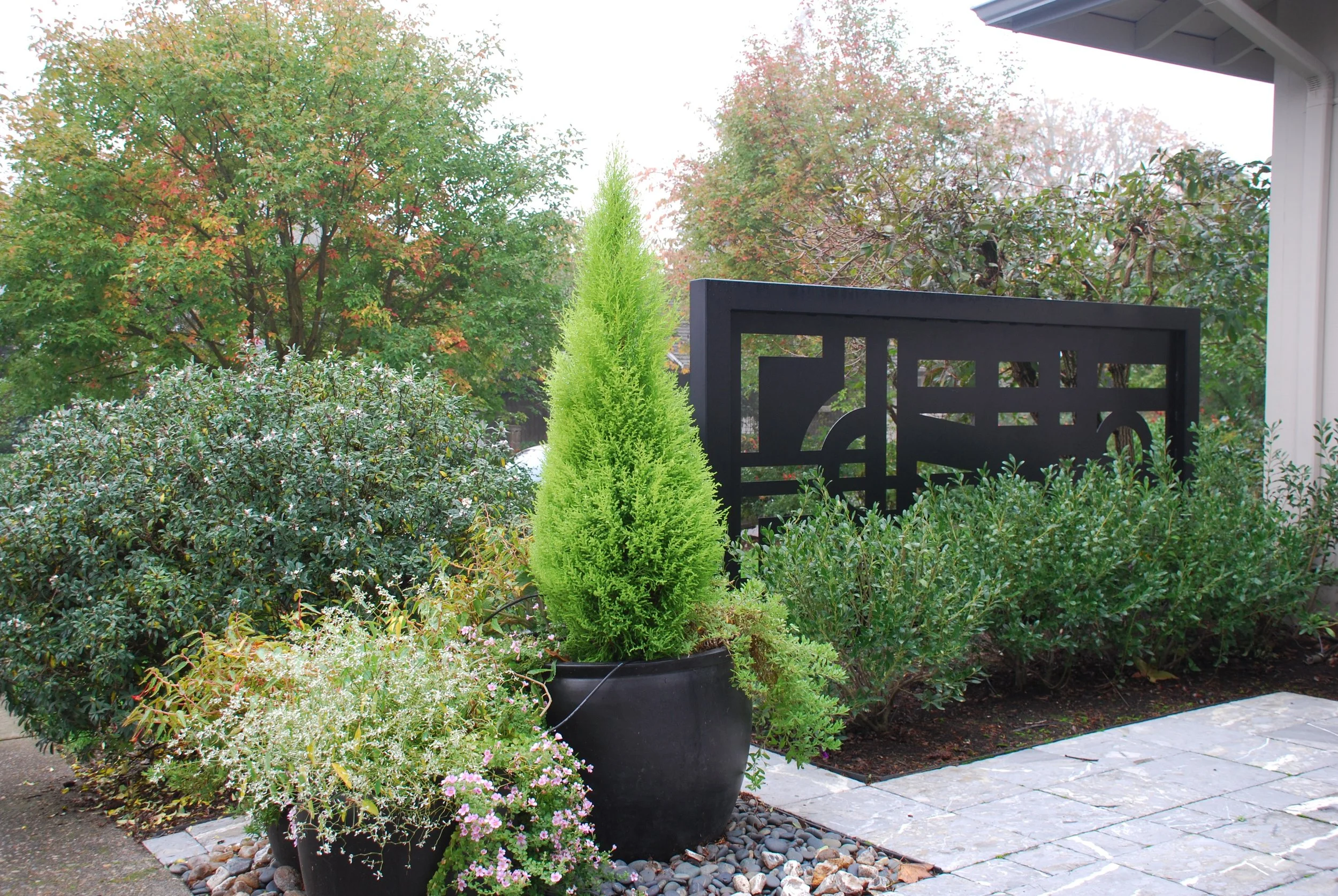 Courtyard trellis gives sense of privacy and an added touch to the front of the house.