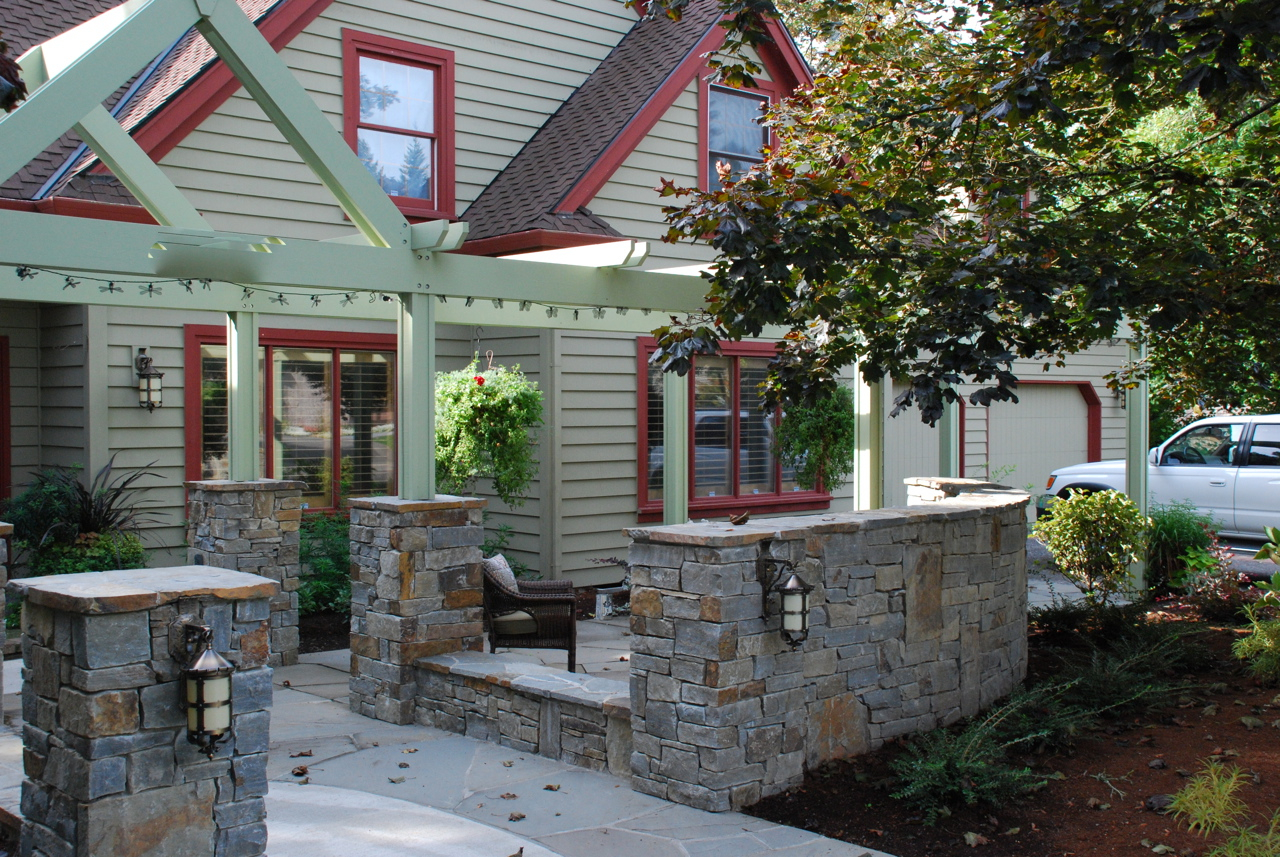 Vancouver After II . Stone walls define a sitting area and entry is set off by an entry pergola