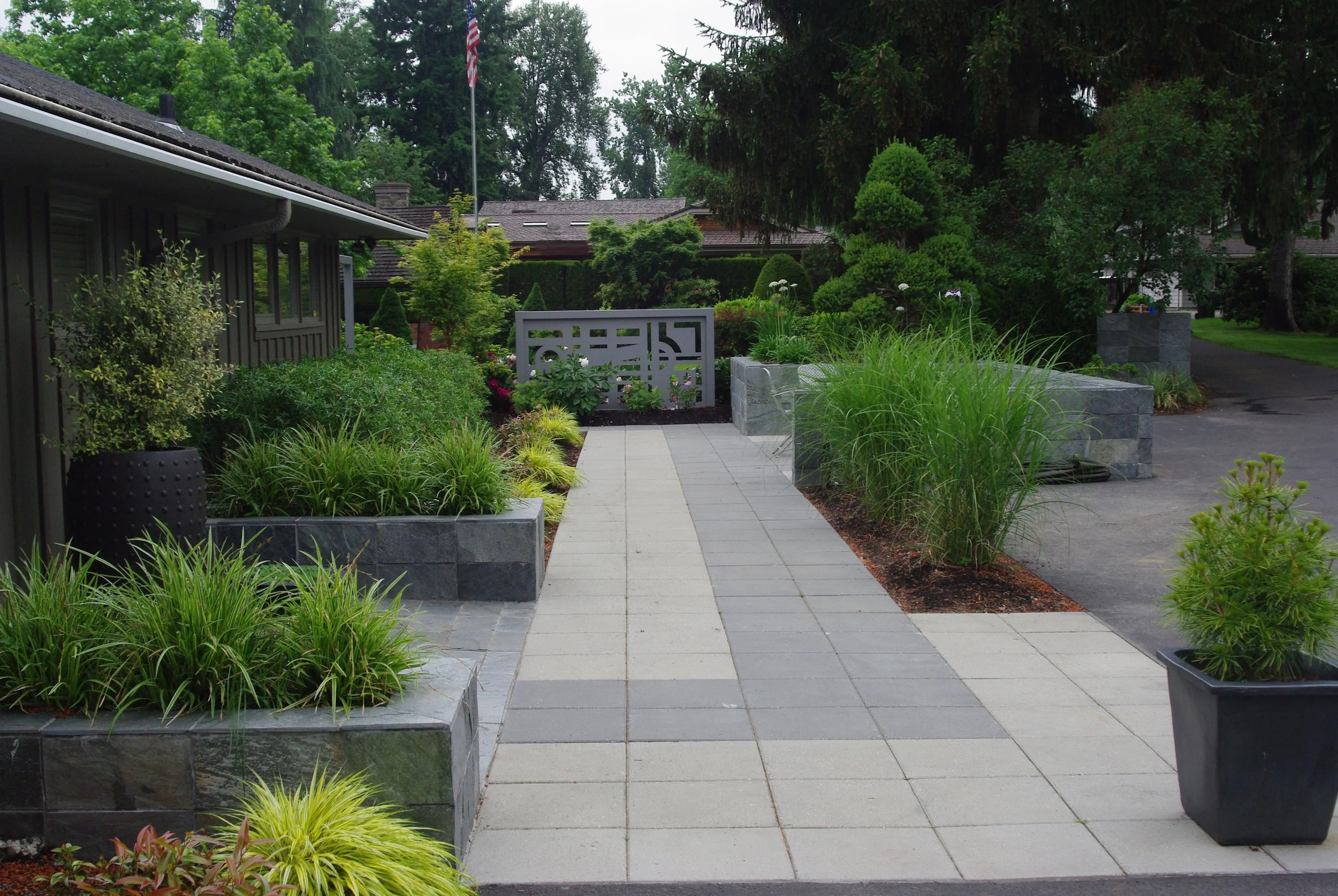 Front entry gains a modern clean look. Christine's art trellis gives the pathway view a stopping point and screens out the neighbors house.