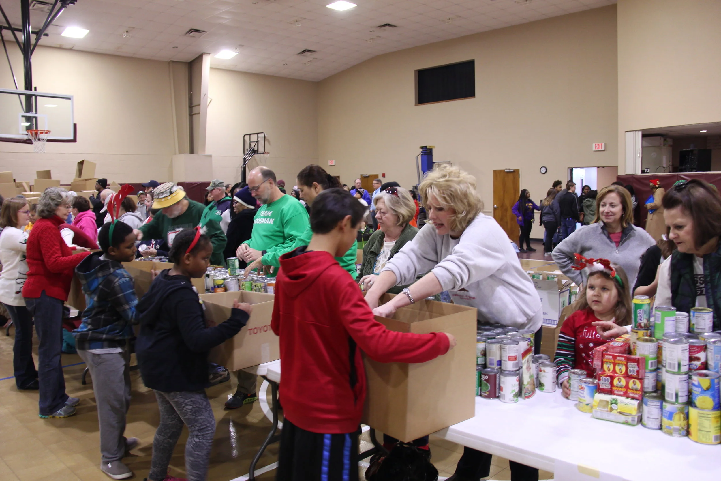From left are Fayette Cares volunteers Jennifer and Casey Clayton sorting thousands of toys to be distributed to disadvantaged children.