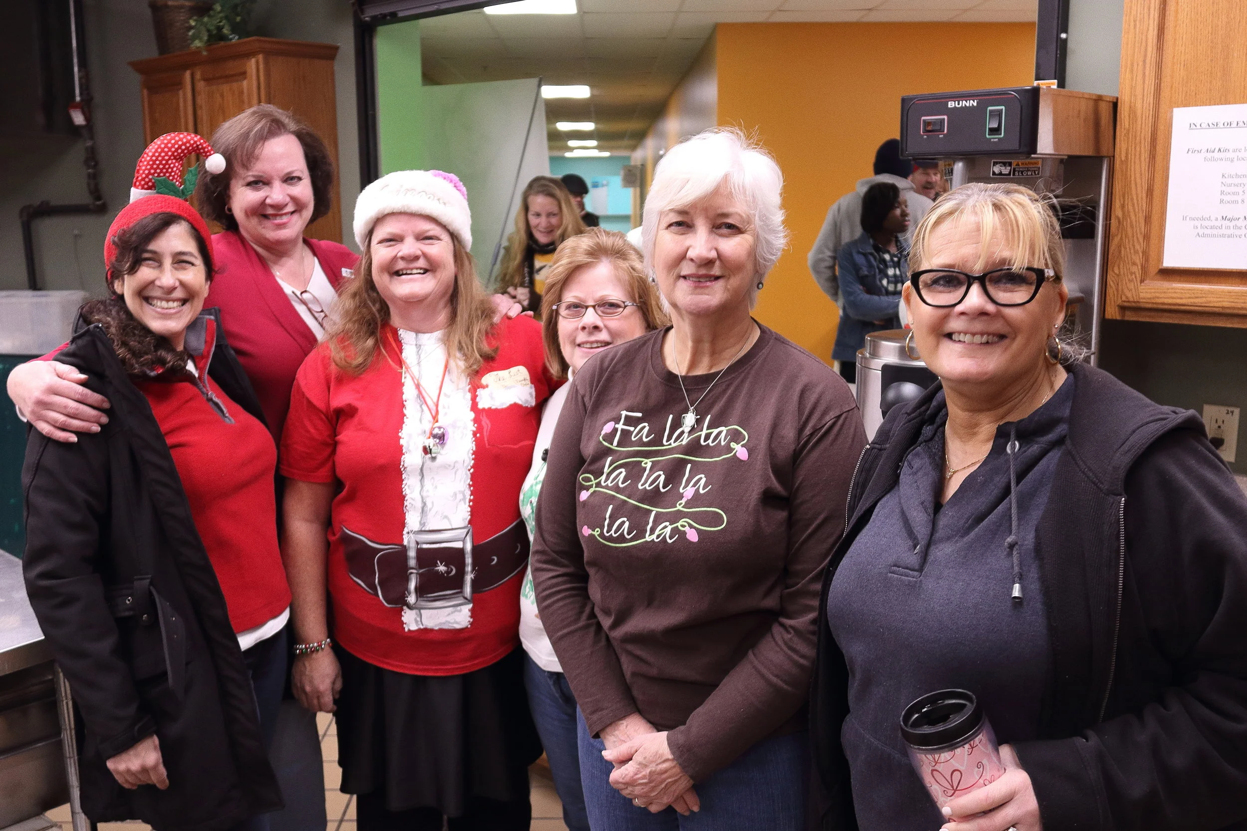 Members of St. Philip the Apostle Catholic Church serve snacks for volunteers at the Fayette Cares Christmas food distribution.