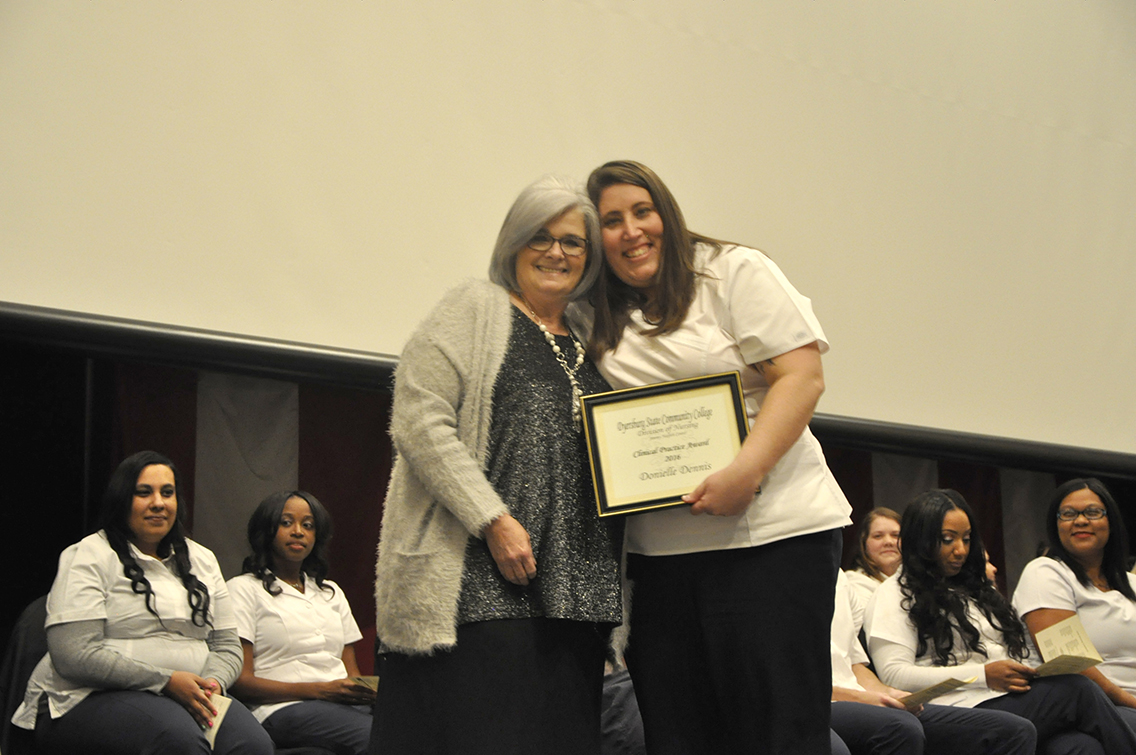 DSCC Nursing Instructor Anne Gregory (left) presented the Clinical Practice Award to traditional nursing class graduate Donielle Dennis (right) of Drummonds during DSCC’s Nursing Pinning Ceremony Dec. 9.