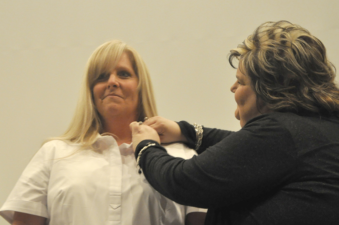 Nursing graduate Miki Glisson (left) of Hornbeak received her nursing pin from Dean of Nursing Amy Johnson (right) during DSCC’s Nursing Pinning Ceremony Dec. 9.