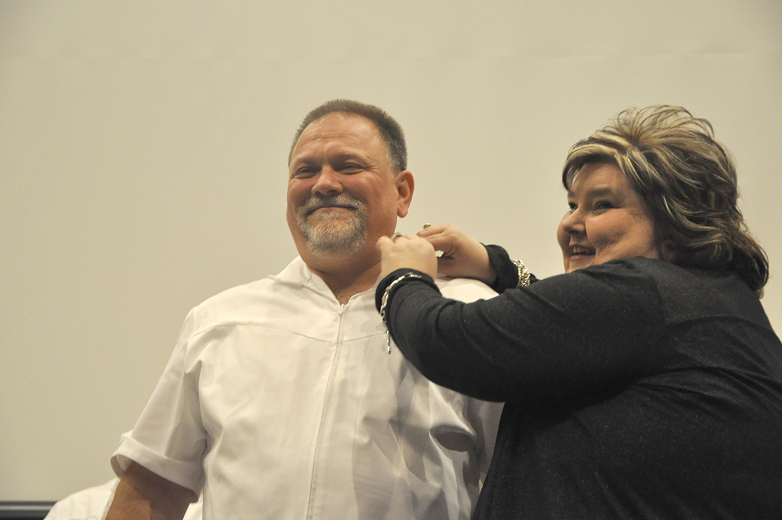 Richard Keenan (left) of Drummonds received his nursing pin from Dean of Nursing Amy Johnson (right) during DSCC’s Nursing Pinning Ceremony Dec. 9.