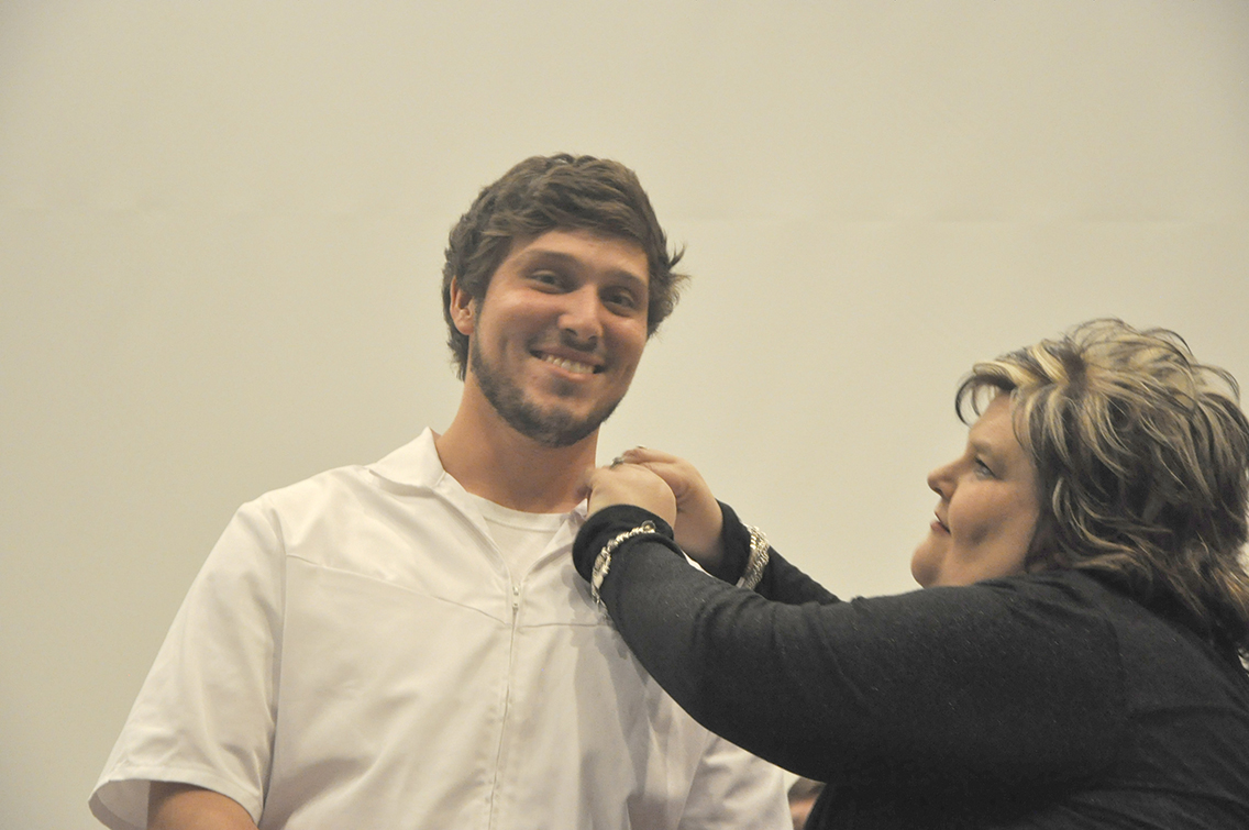J.B. Laxton (left) of Munford received his nursing pin from Dean of Nursing Amy Johnson (right) during DSCC’s Nursing Pinning Ceremony Dec. 9.