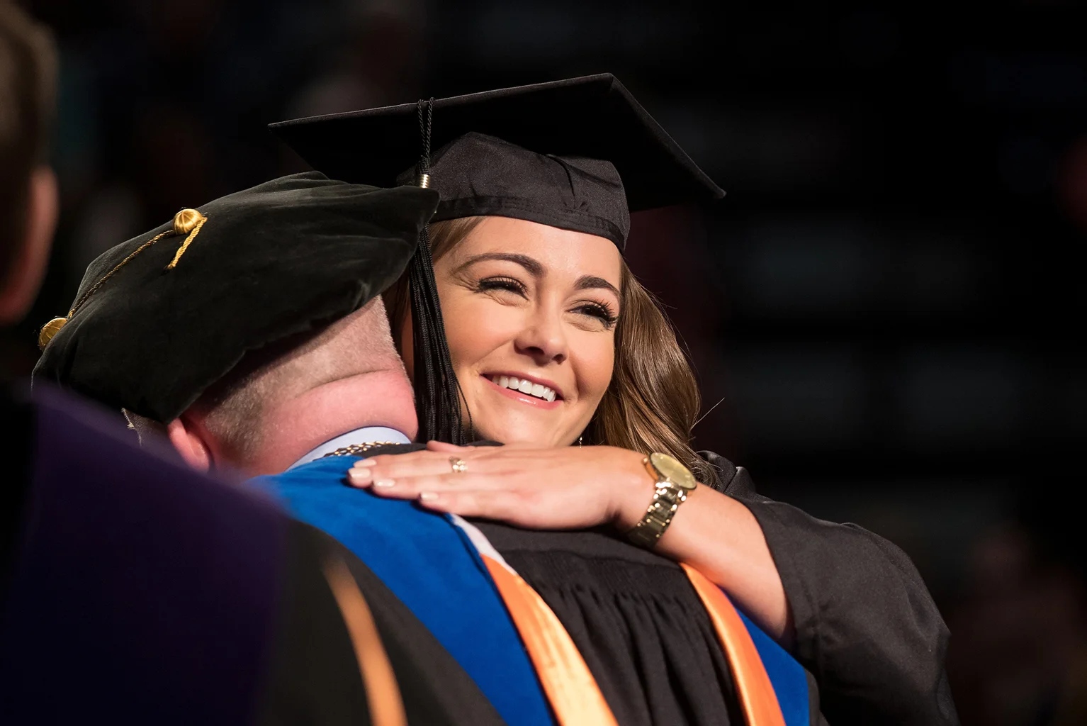Hannah Robison, of Springville, hugs UT Martin Chancellor Keith Carver as she crosses the commencement stage May 7.