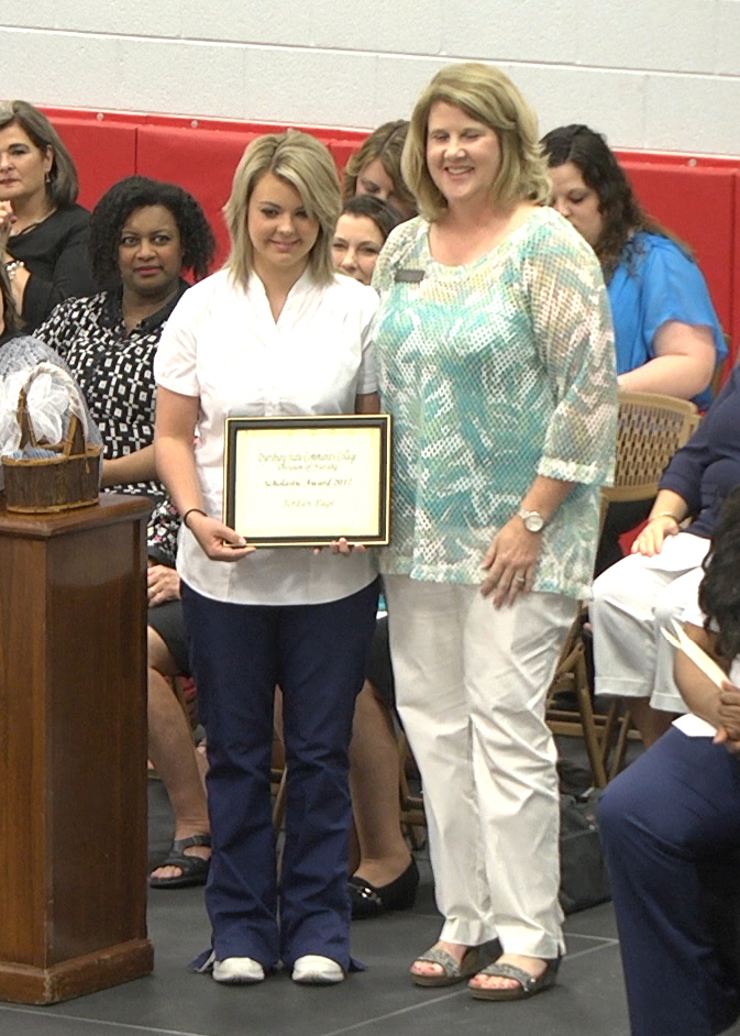 DSCC nursing instructor Kimberly Dew (right) presented the Scholastic Award to nursing graduate Jordan Page (left) of Kenton for achieving a 3.38 GPA in the traditional nursing program.