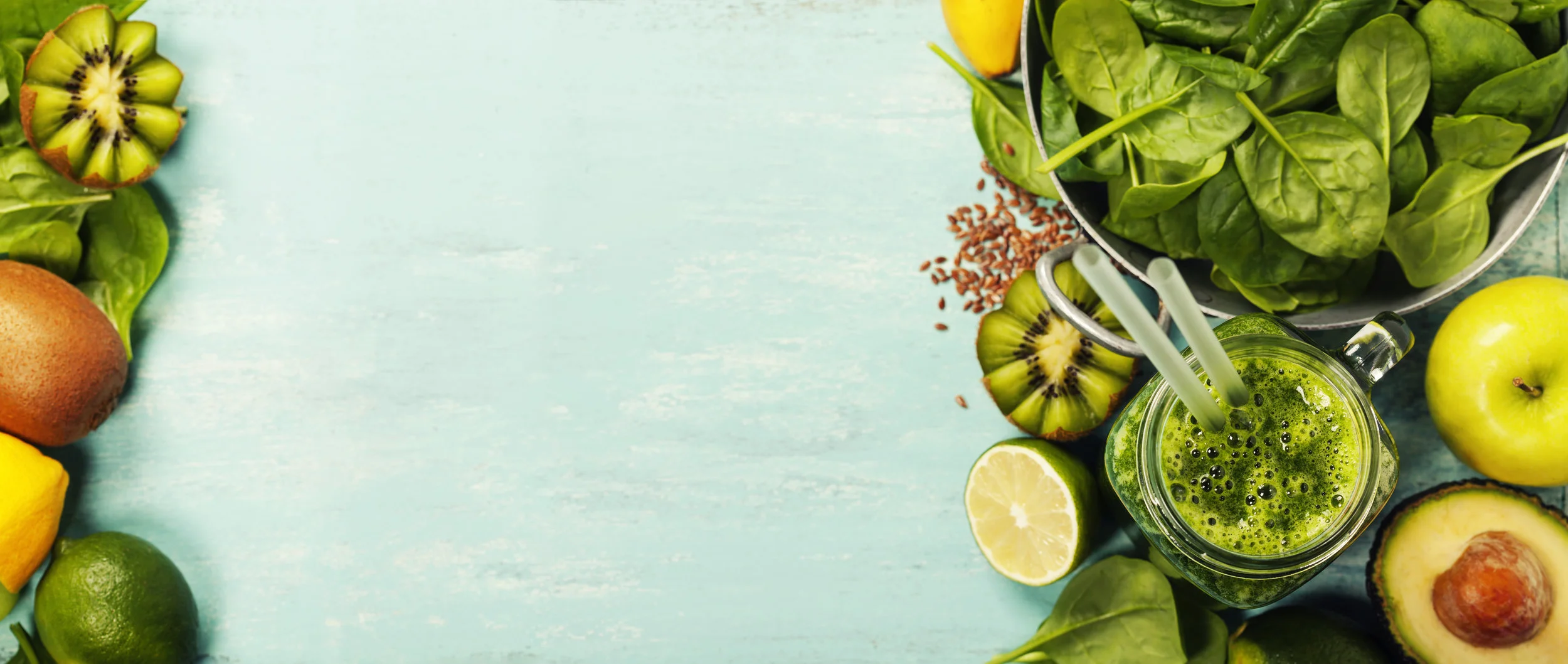 Healthy-green-smoothie-and-ingredients-on-blue-background-639584308_8551x3619.jpeg