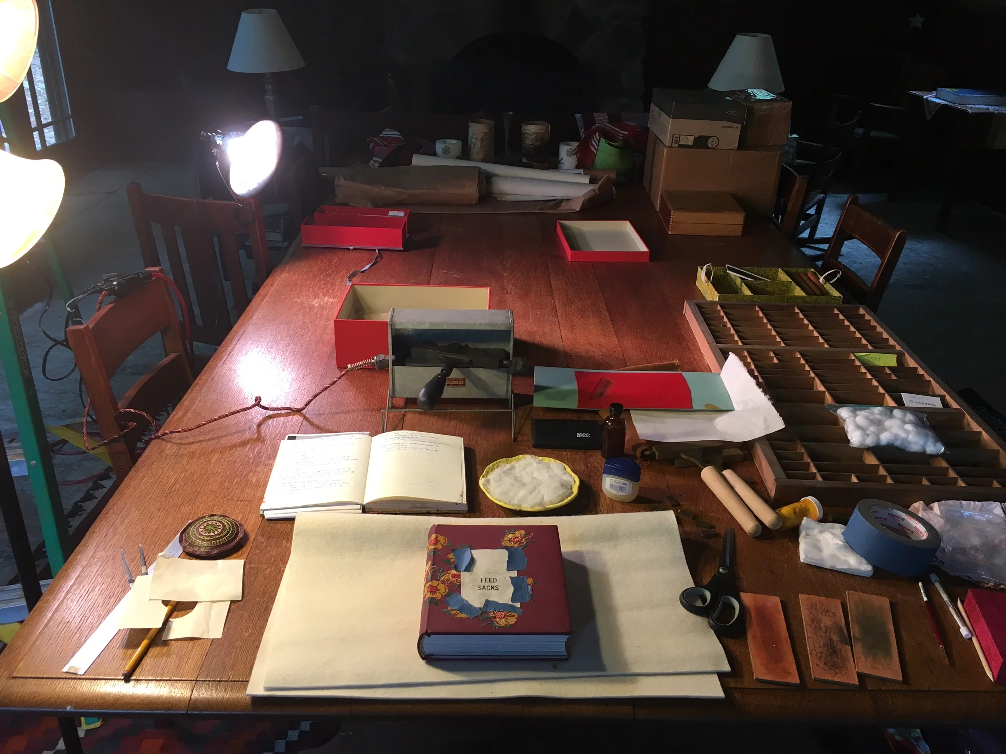 My tooling set up: tissue for creating the layout, my tooling notes from school, a cotton pad for cooling of my tool, a sweet french stove that Todd lent me, fixor, type, suede pads for cleaning of the tools, and my book.