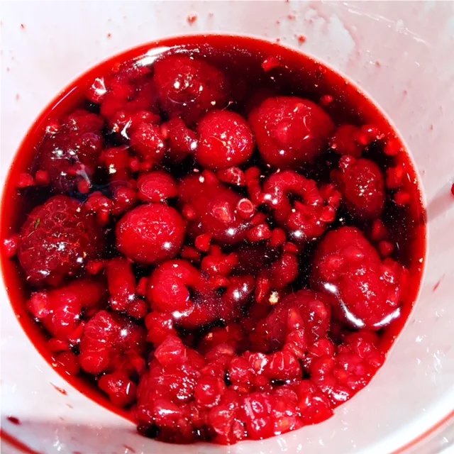 Raspberries in light syrup, thawed overnight in the fridge. You can find these in the frozen fruit aisle at the grocery store.