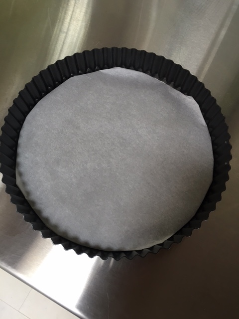 Wrap the bottom of your tart pan in parchment paper.