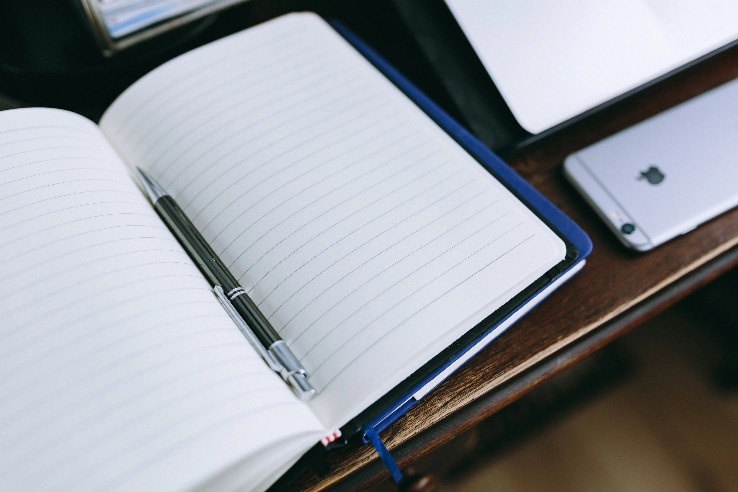 kaboompics.com_A blank notebook with pen.jpg