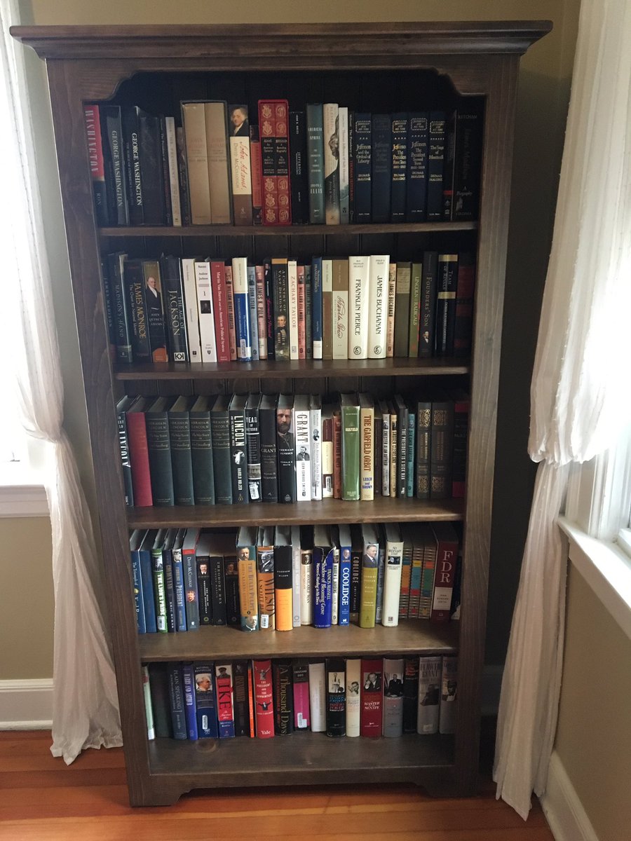 Just one of two bookcases filled with unread books. 