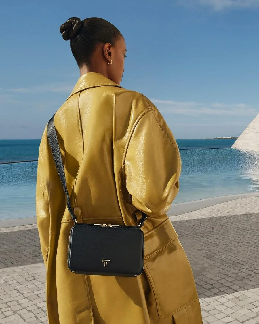 TUMI-50th-Anniversary-Campaign_Voyageur-Myla-Crossbody-in-Black_Light-Gold.jpg