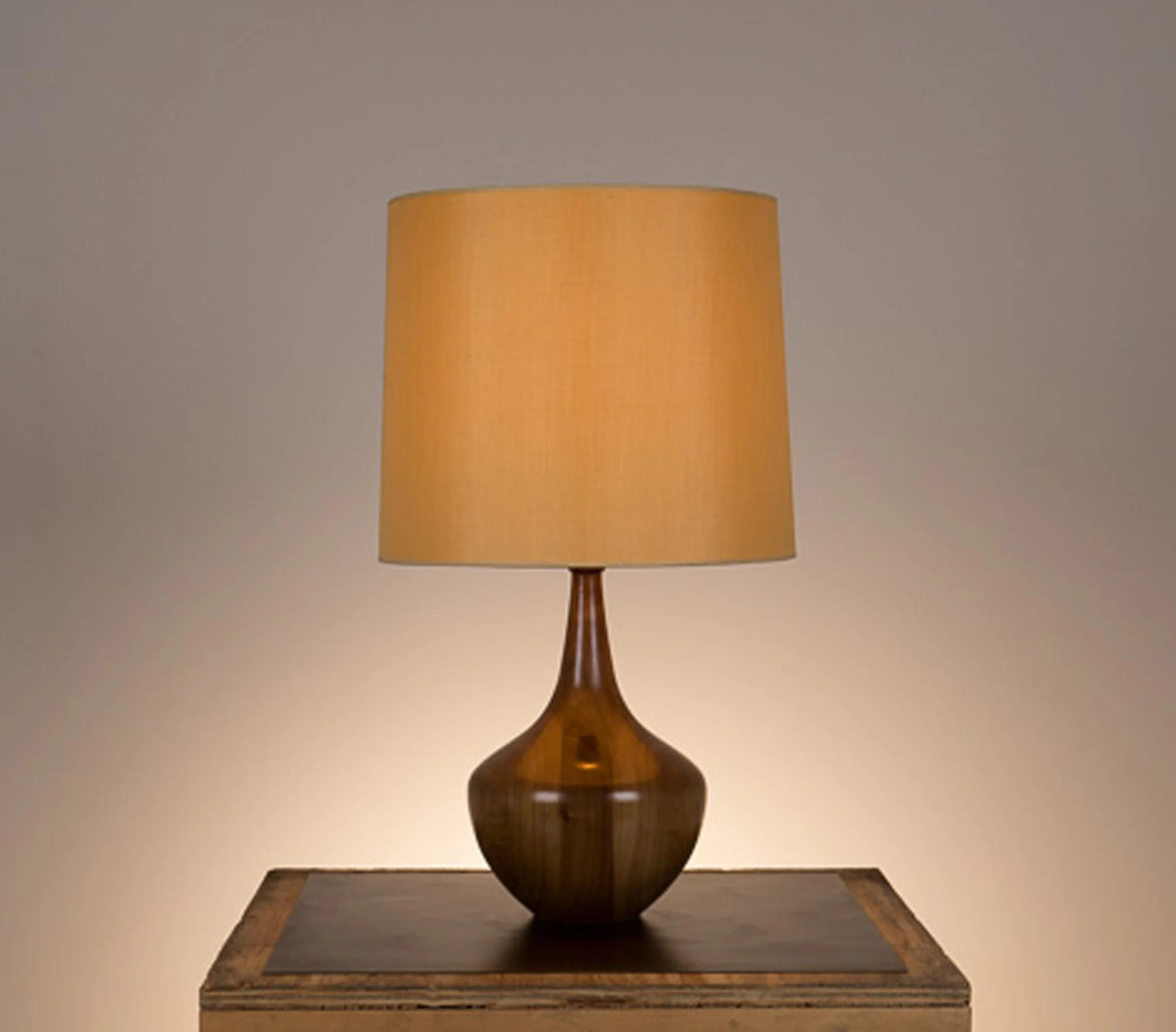Bradley Table Lamp #1 Walnut in a medium brown finish. Semi-closed top lamp shade in gold silk.