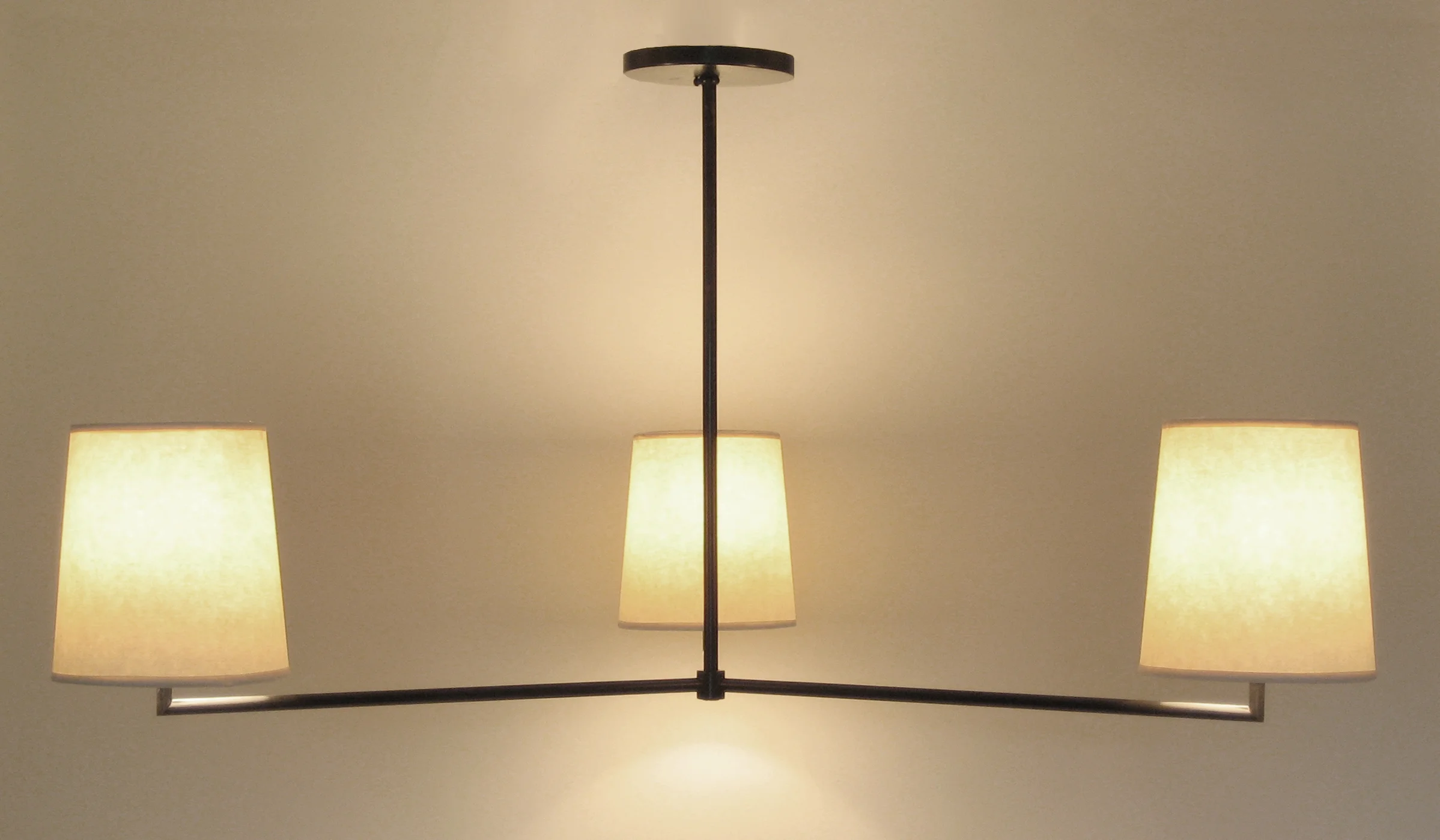 Jasper J Three Arm Chandelier Bronze / parchment shades.