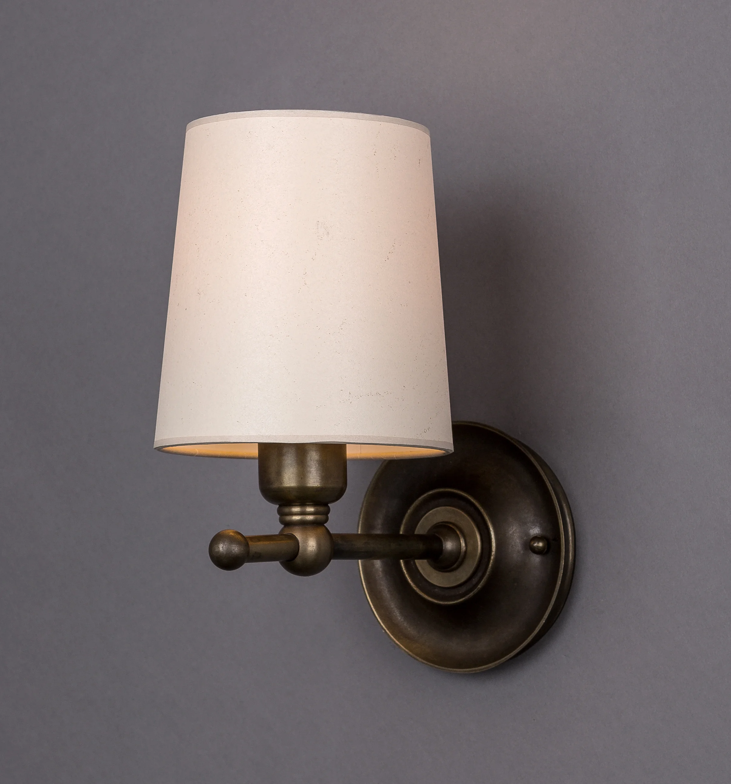 Dexter Sconce Dark antique brass / parchment shade.