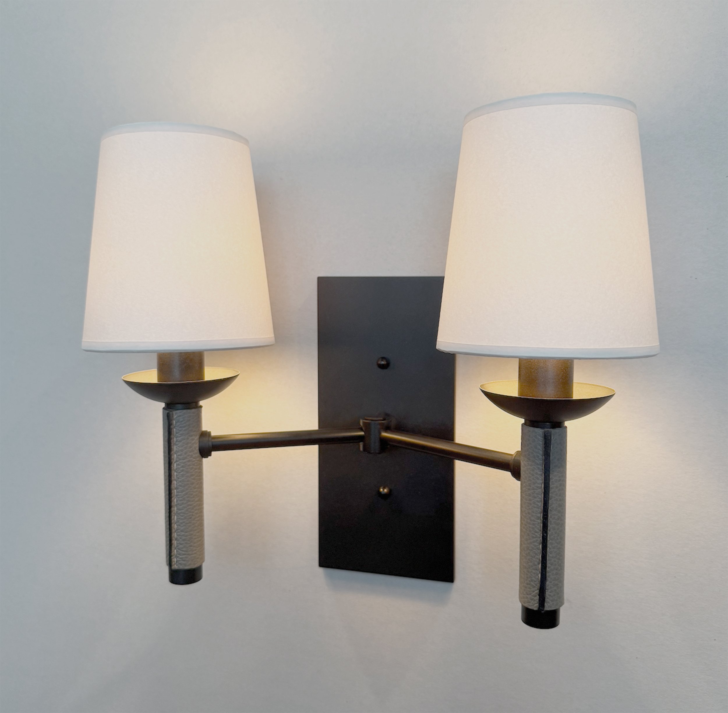 double sconce in blackened bronze and leather
