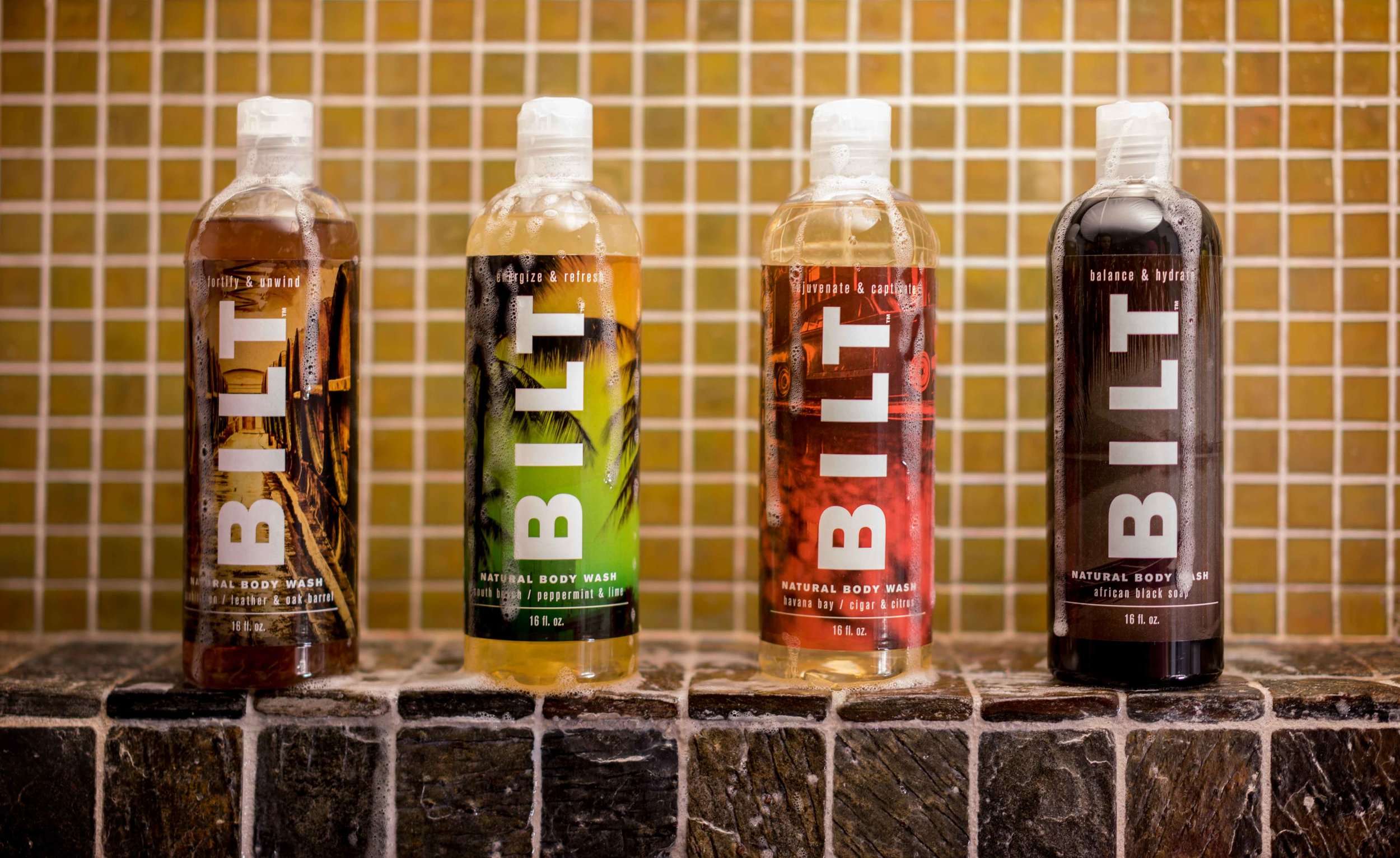 * 4 bottles of BILT body wash inside a shower