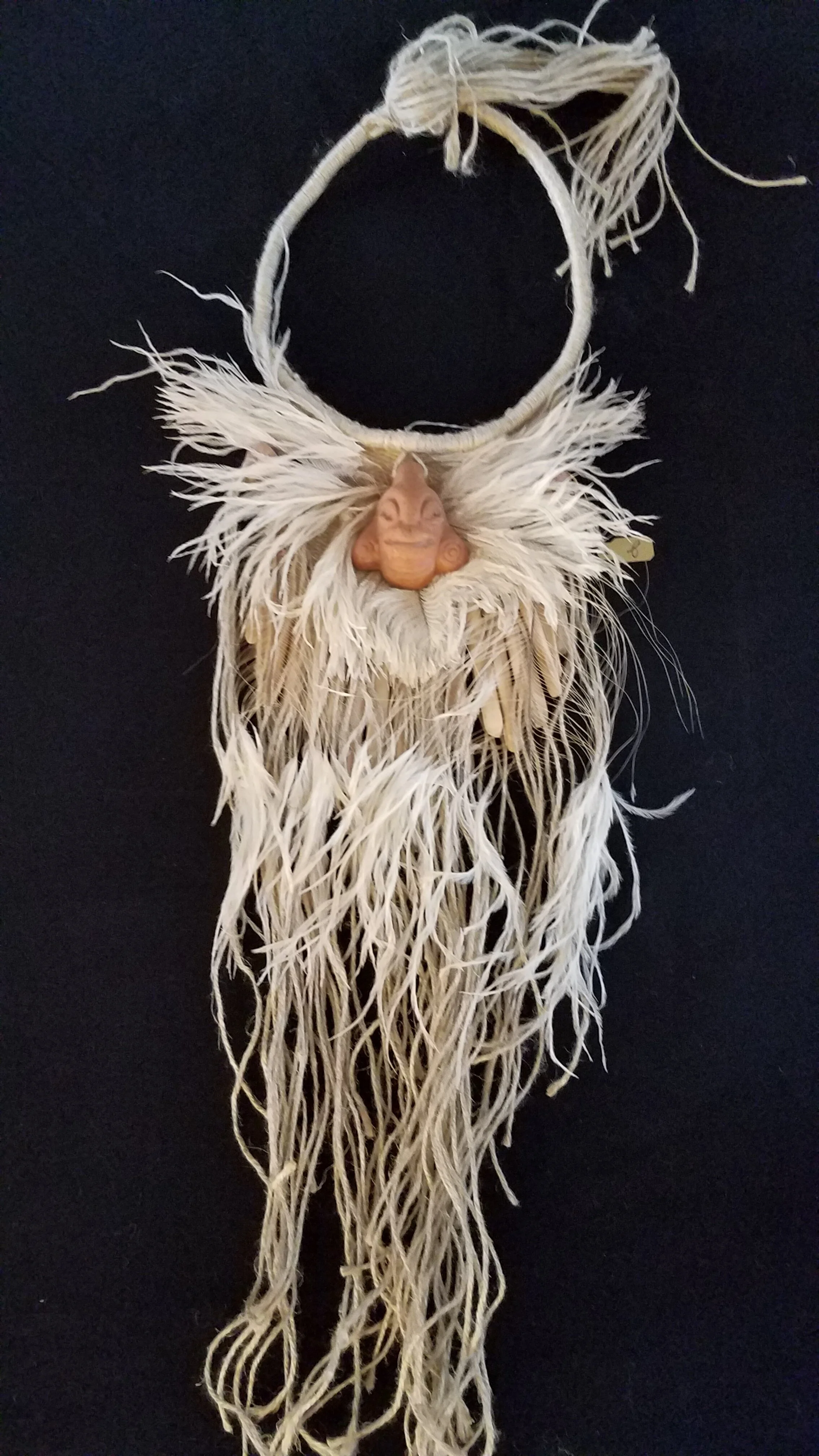 Clay Amulet and Feathers