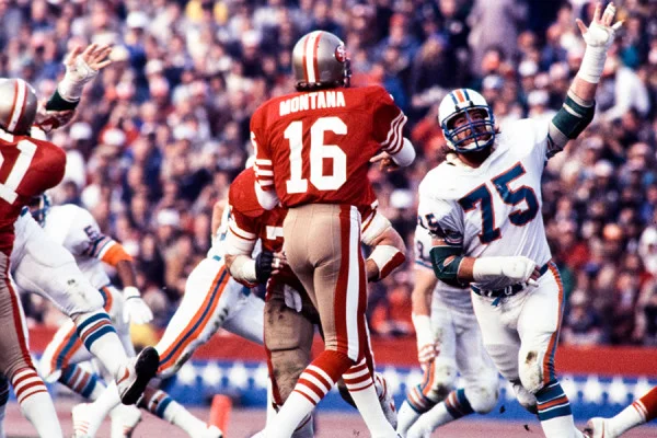 Miami Dolphins defensive end Doug Betters (75) chases San Francisco quarterback Joe Montana during an NFL game. Dave Cross photo | Courtesy Miami Dolphins