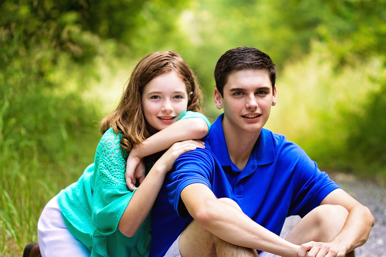 sibling in green and blue on forest path.jpg