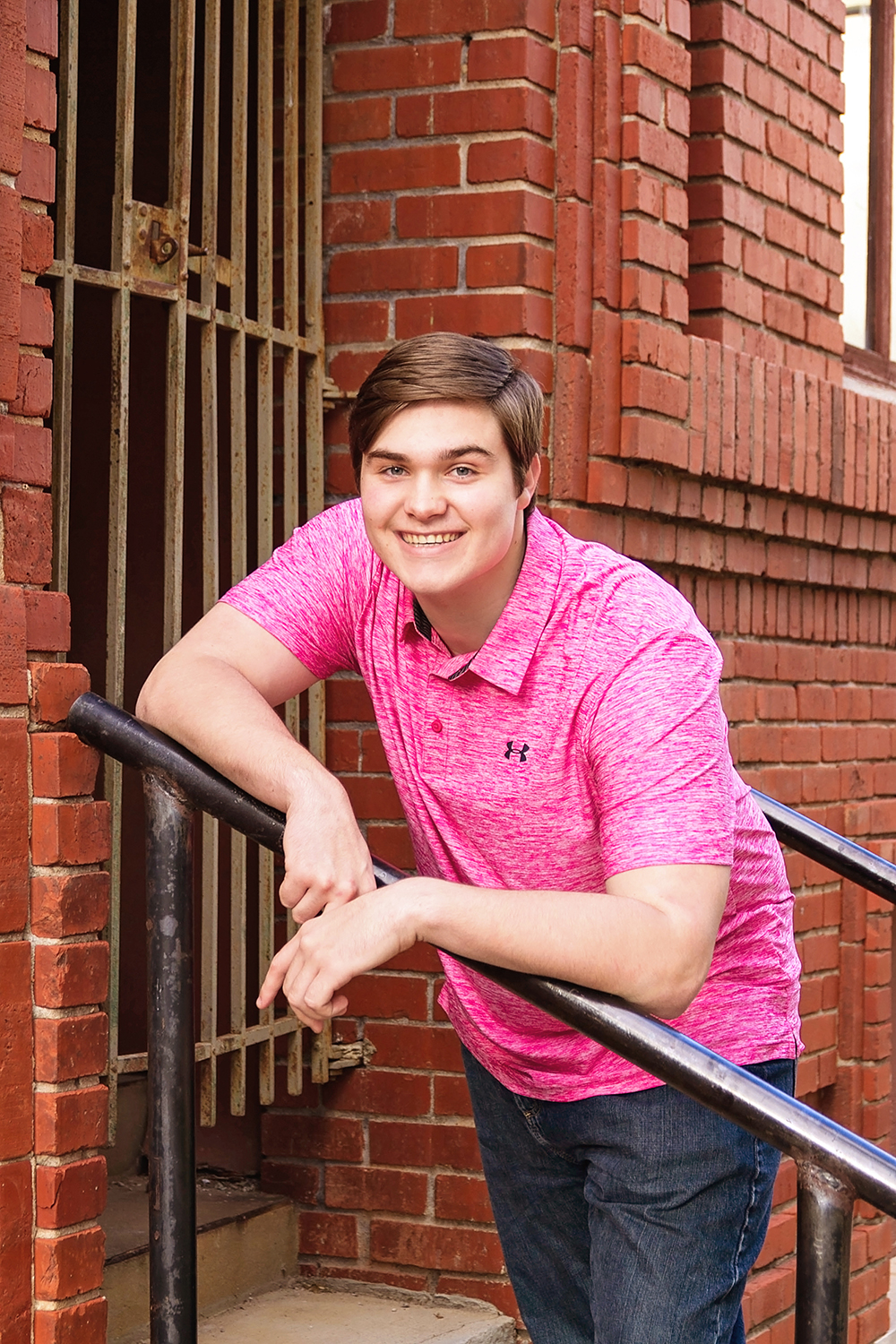 guy in pink shirt on stairs.jpg