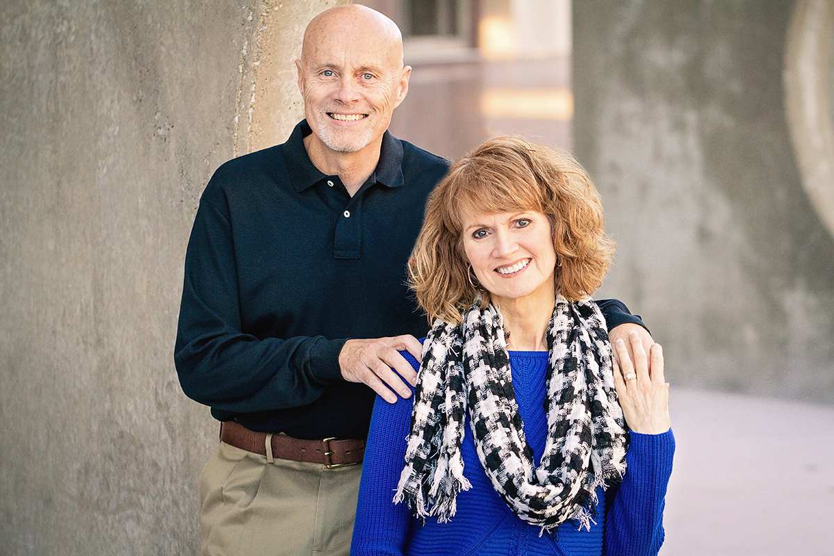 couple in black and blue sitting by sculpture.jpg