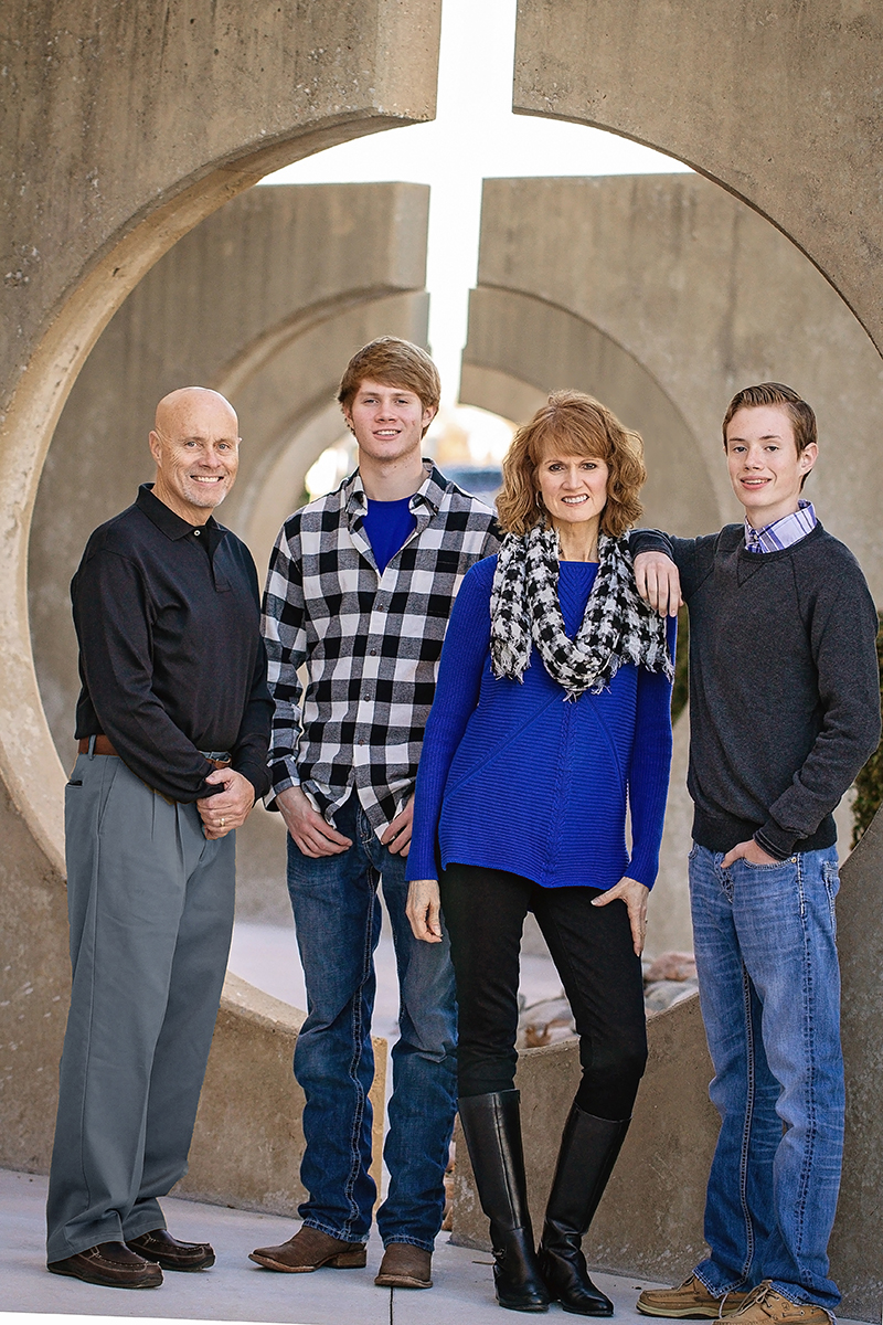 family of four by cement sculpture in black and blue cross in light.jpg