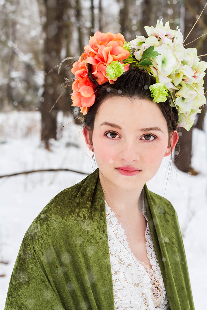 girl with brown eyes wearing floral crown in snow.jpg