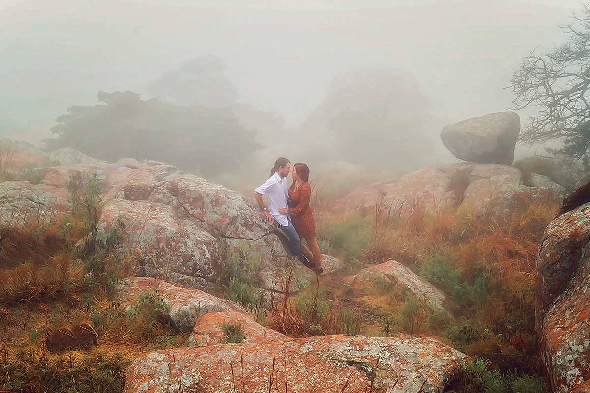 Couple in fall colors in the fog among rocks and foilage.jpg