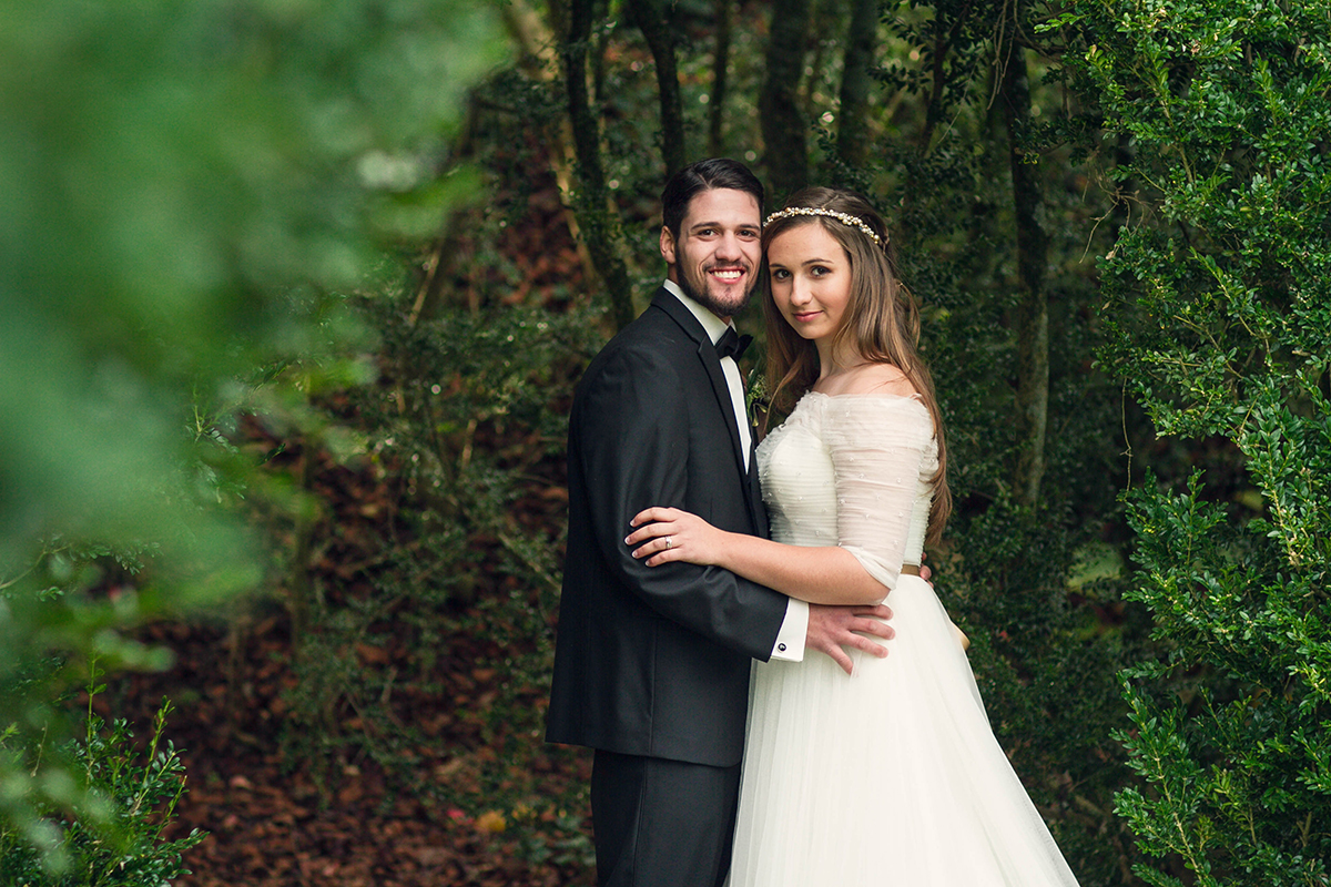 Interlocked wedding couple in the green forest.jpg