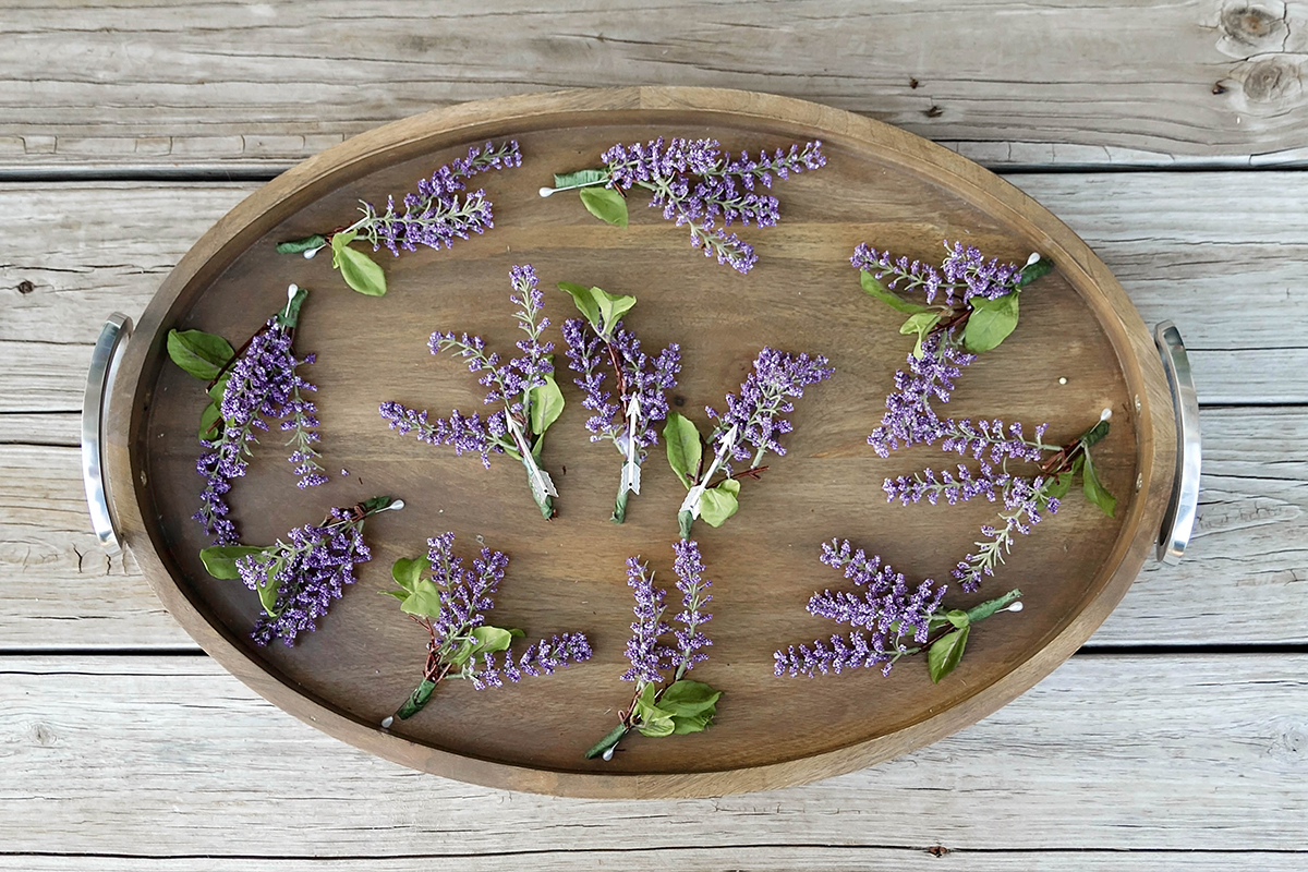 a tray full of lavender boutineers.jpg