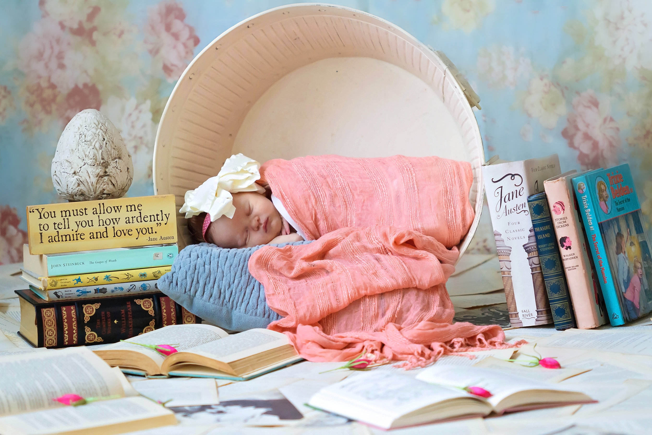 baby in pink surrounded by books.jpg