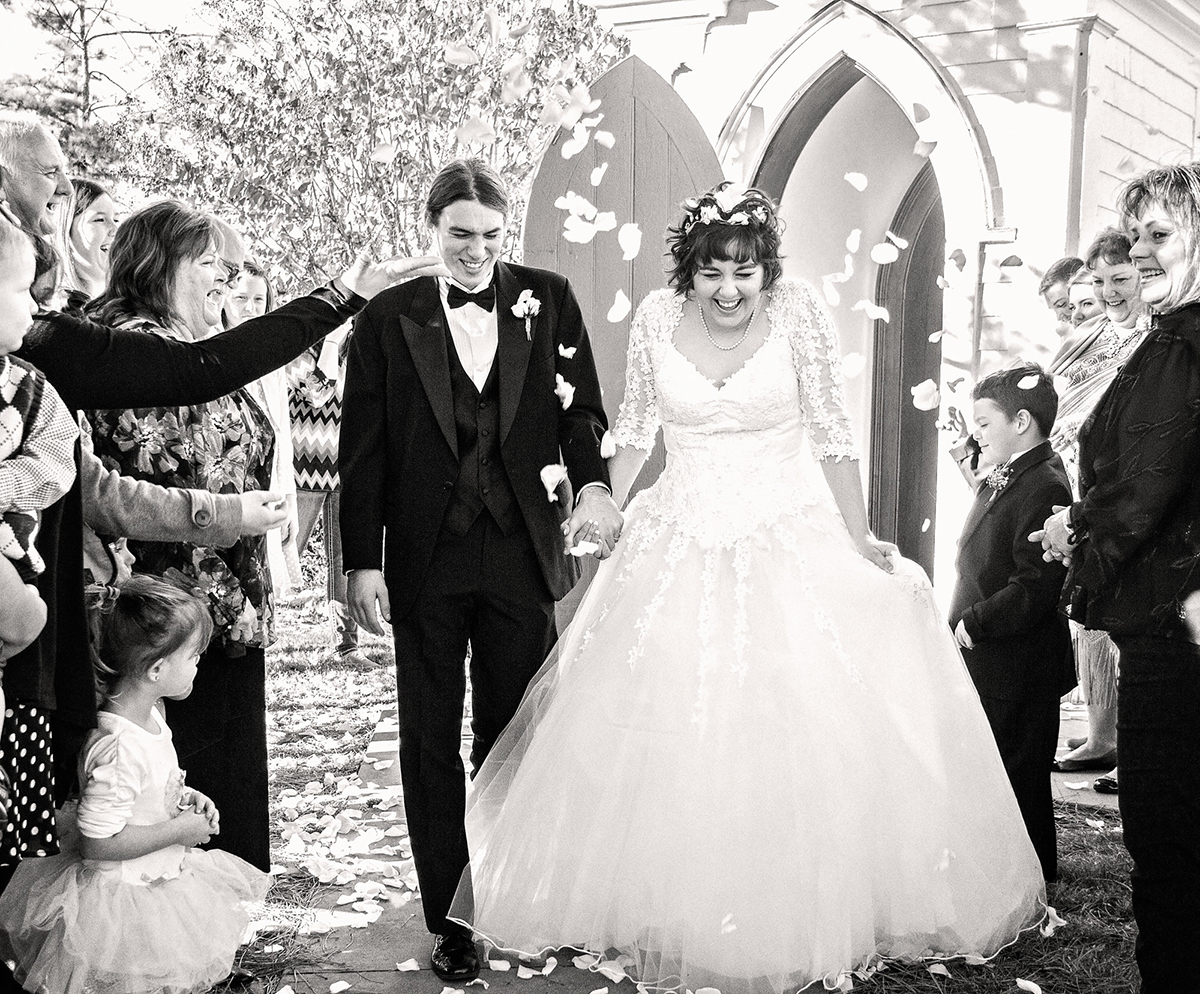 Bride and Groom leaving the church amidst flower petals.jpg