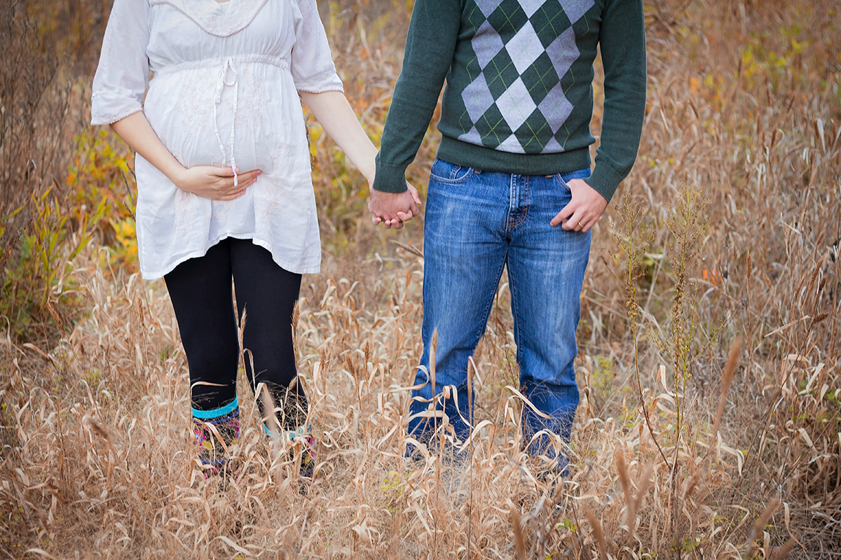 Hipster Couple holding hands and baby bump.jpg