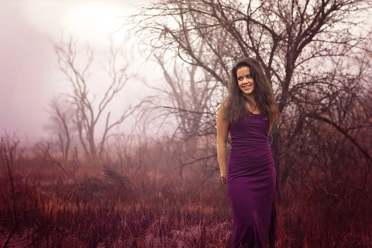 Senior Girl in purple dress standing in a field.jpg